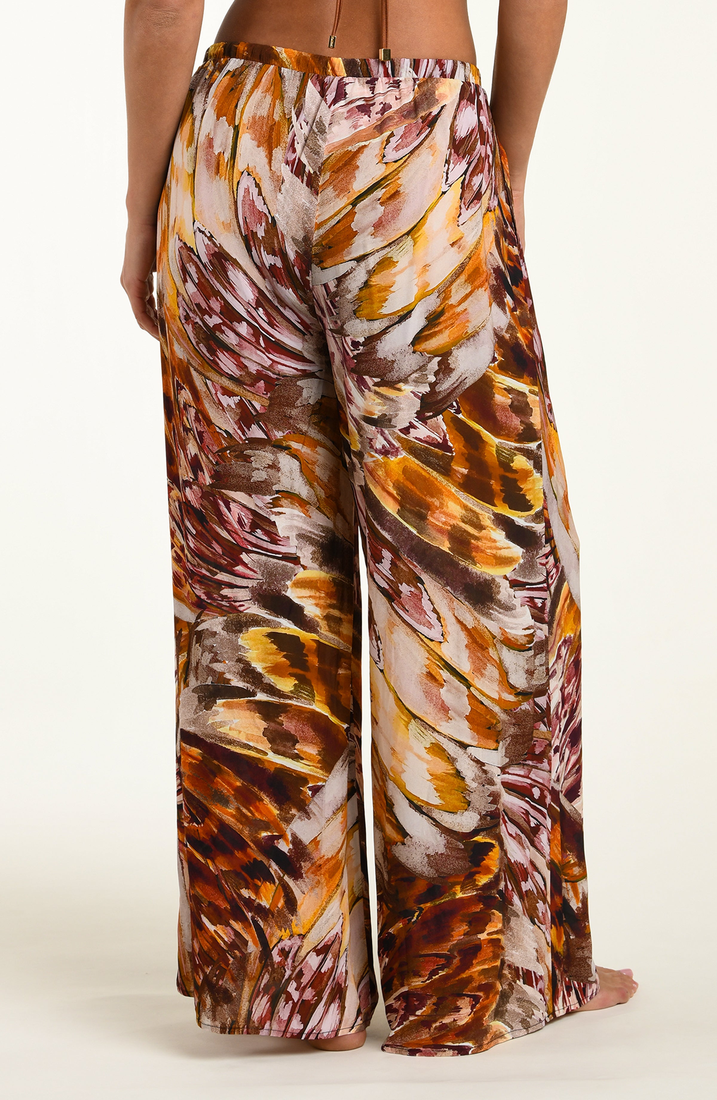 Woven pants with a multicolor pattern on a white background