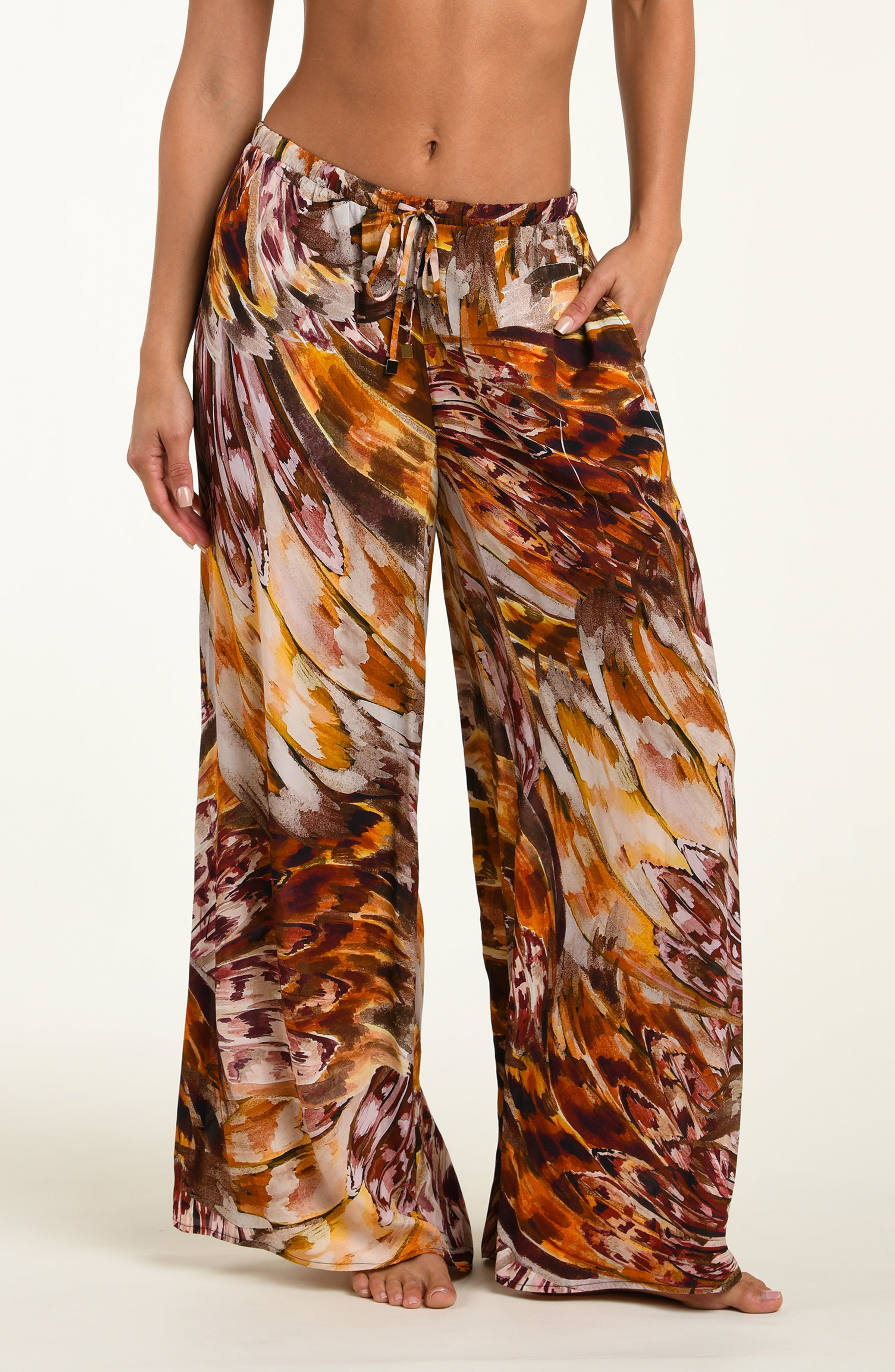 Floral patterned pants worn by a person on a white background