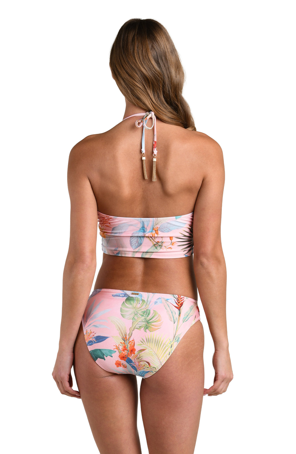Woman wearing a multicolored tropical printed midkini top and matching bottom against a white background. 