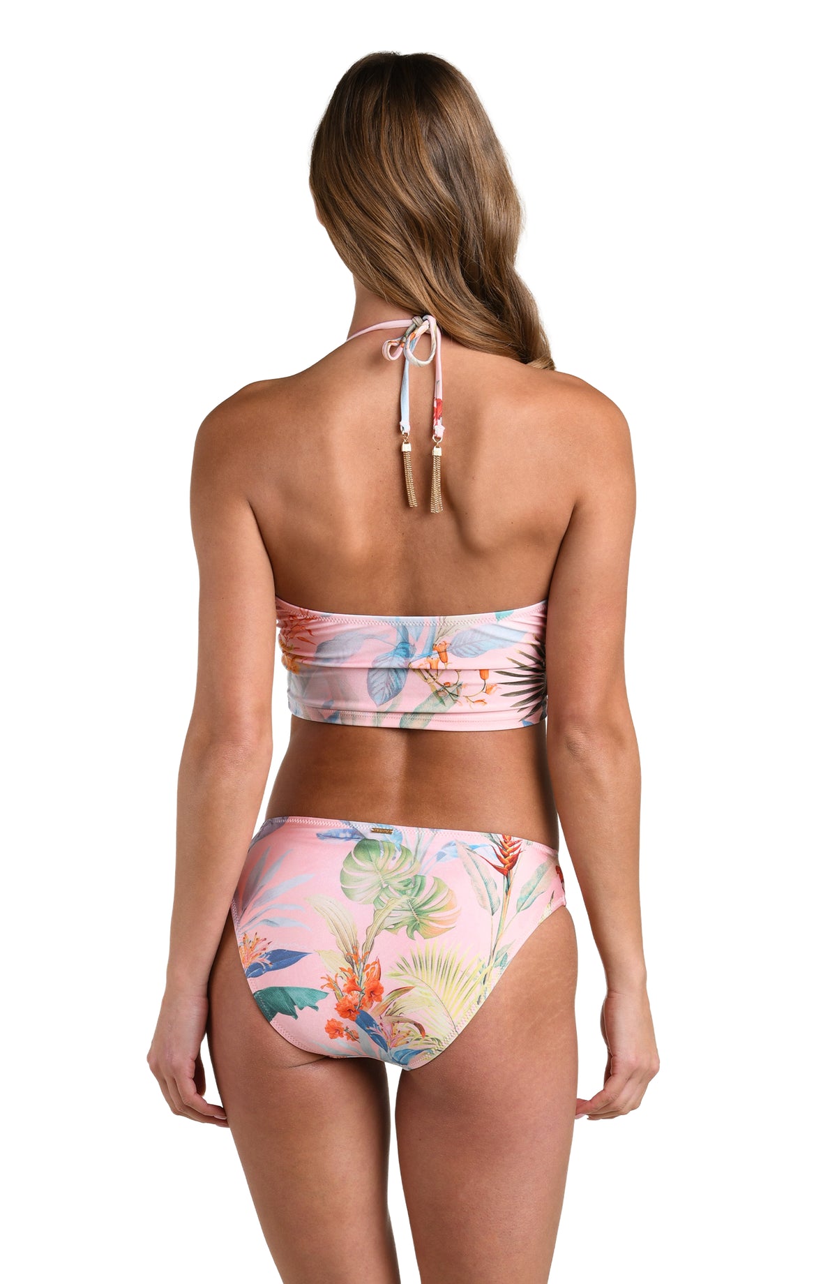 Woman wearing a multicolored tropical printed midkini top and matching bottom against a white background. 