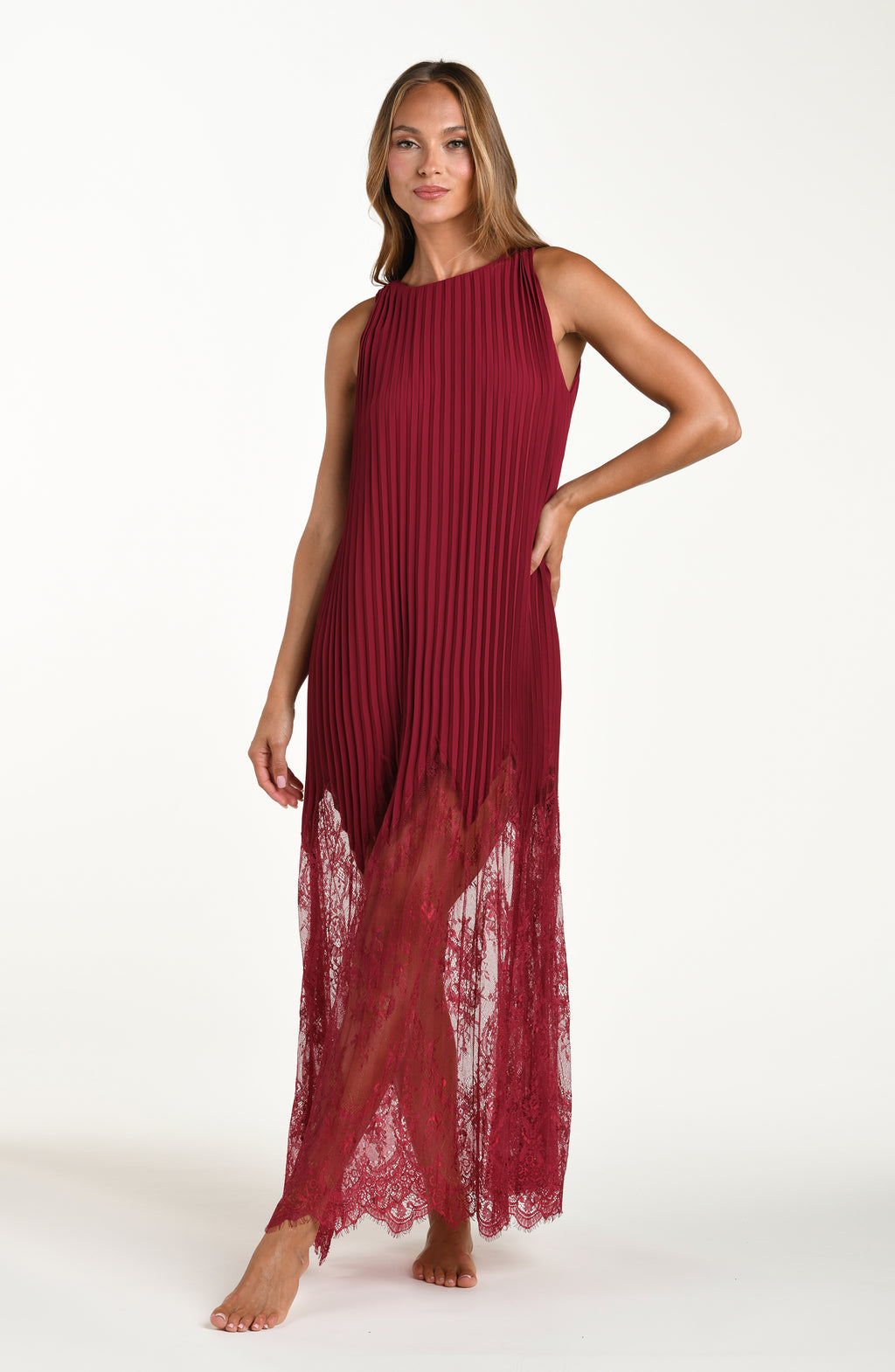 Woman wearing a dark cherry maxi dress against a white background. 