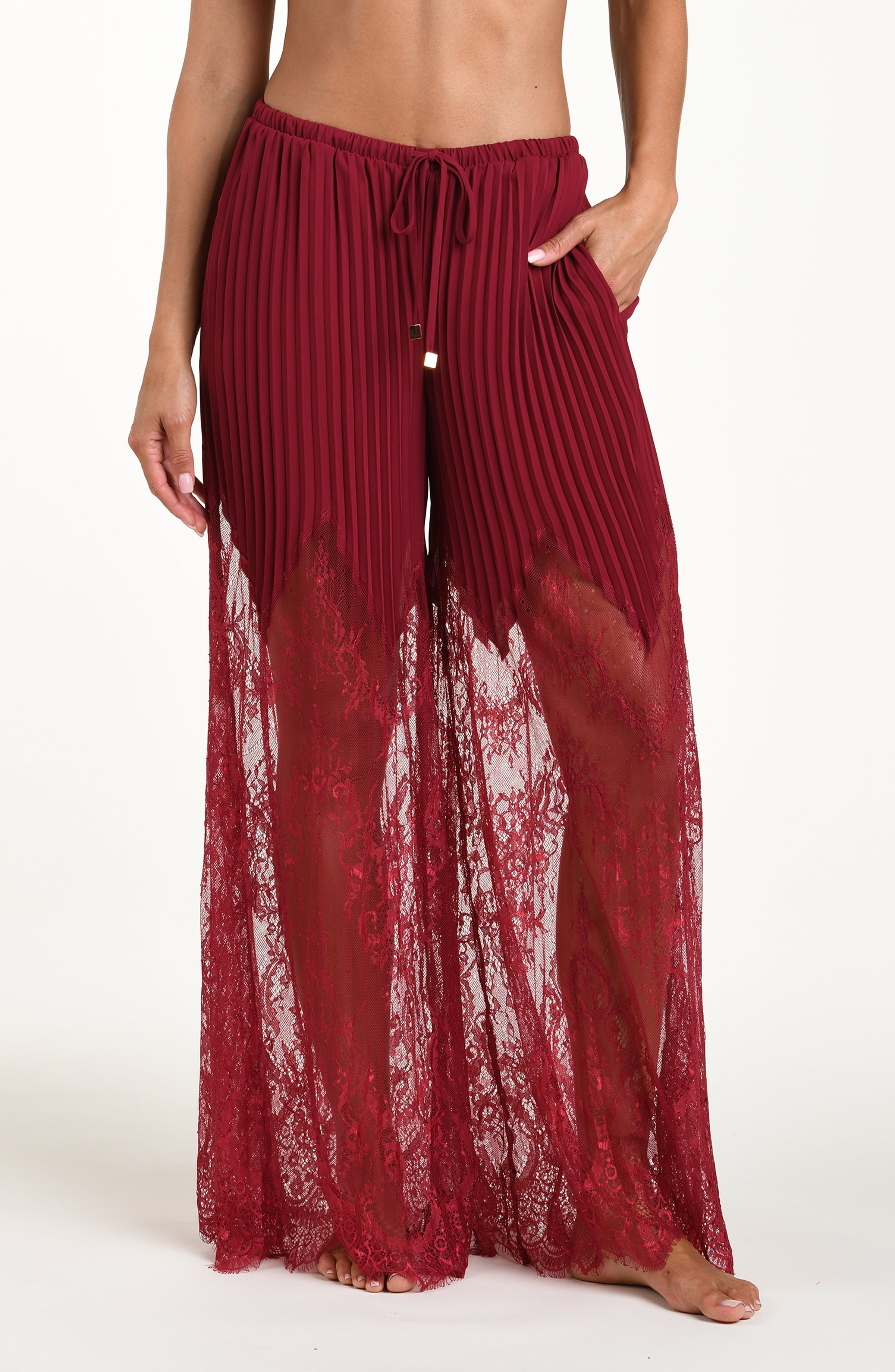 Black cherry pants worn by a person on a white background