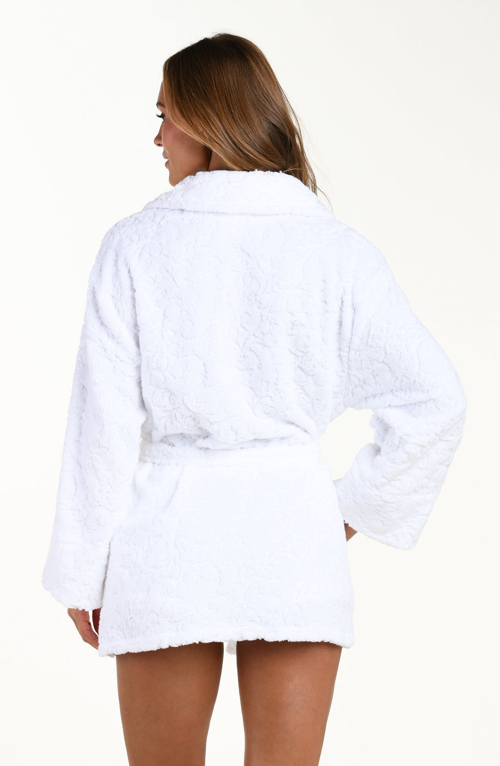 Back image of model wearing solid white jacquard kimono robe featuring a clean back, removable belt, front pockets, long sleeves, and side pockets.