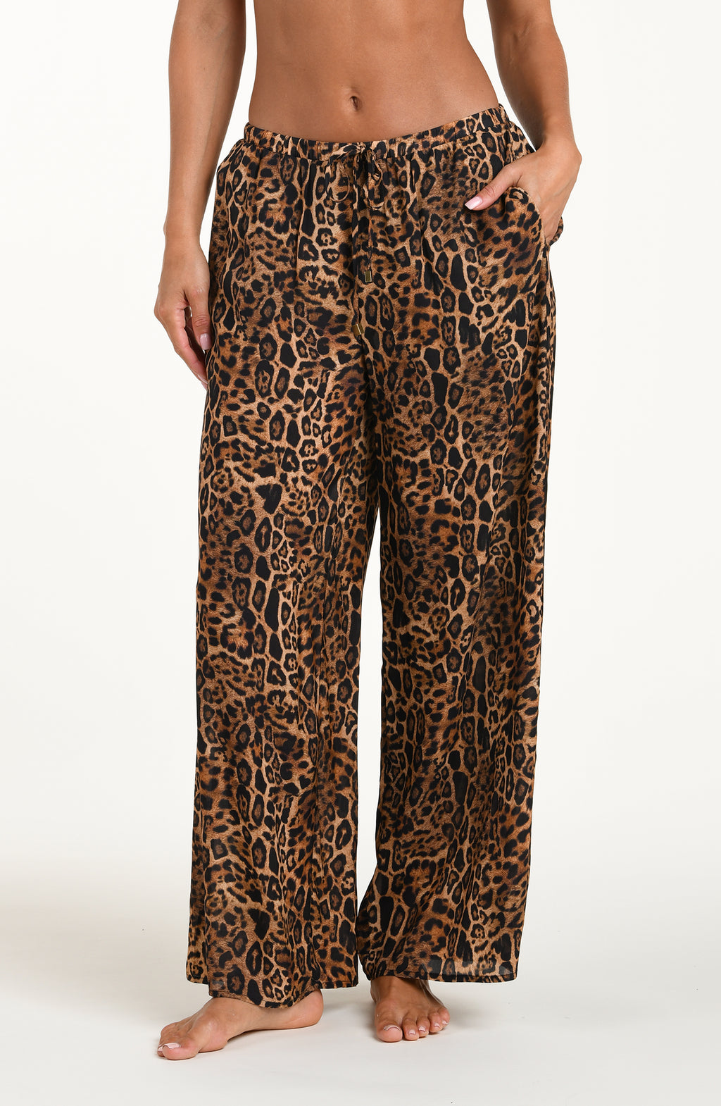 Leopard print pajama pants worn by a person on a white background