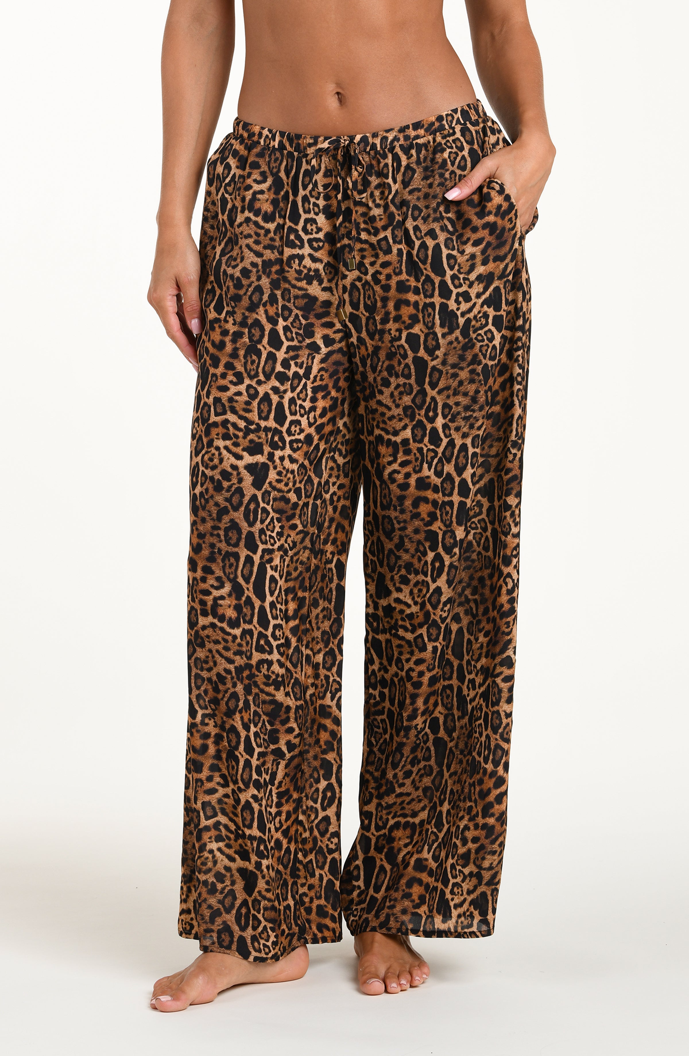 Leopard print pajama pants worn by a person on a white background
