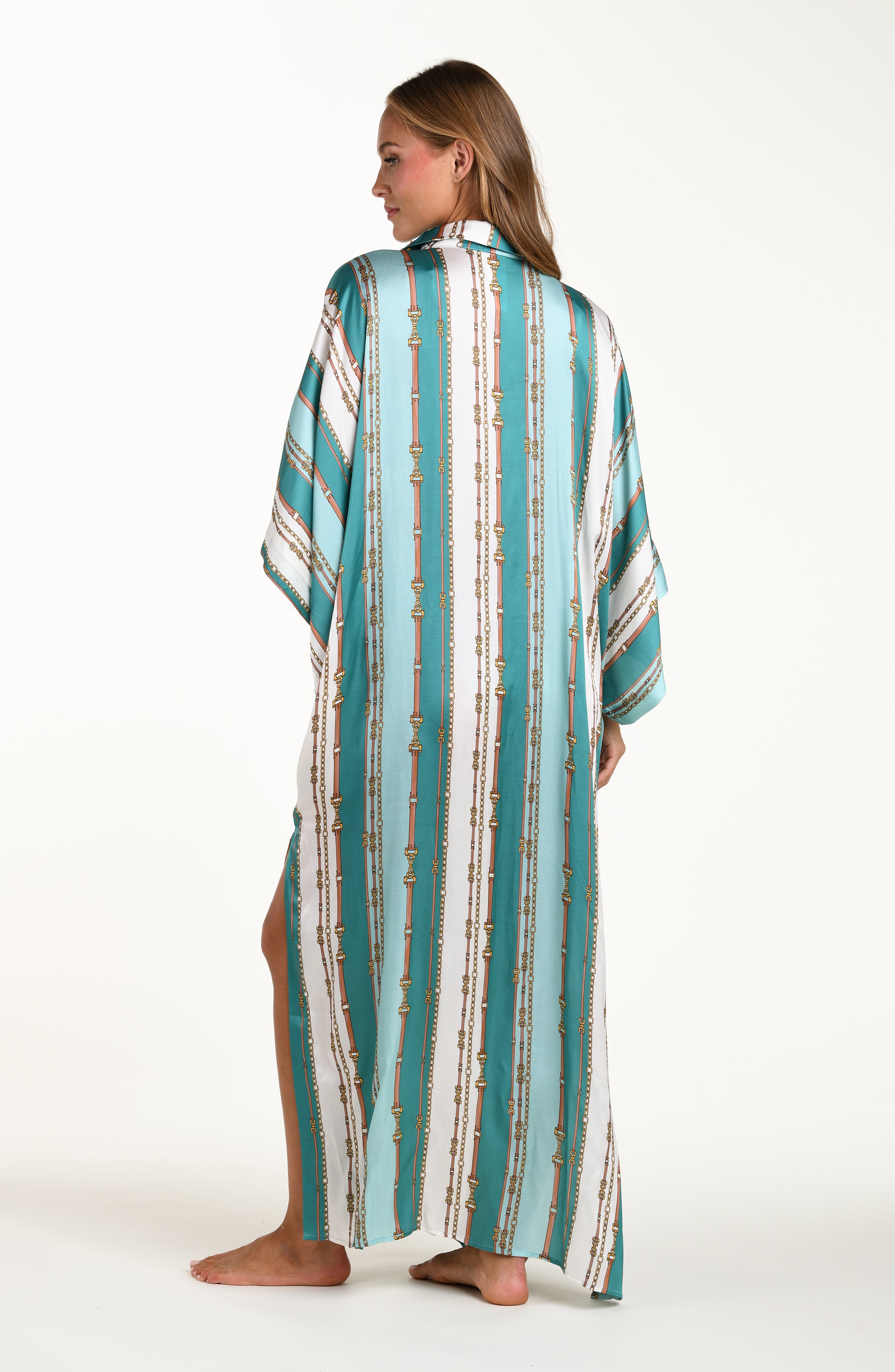 Back image of model wearing a belt-and-chain printed shirt dress cover up featuring a maxi length, collared, with short sleeves and a clean back. 