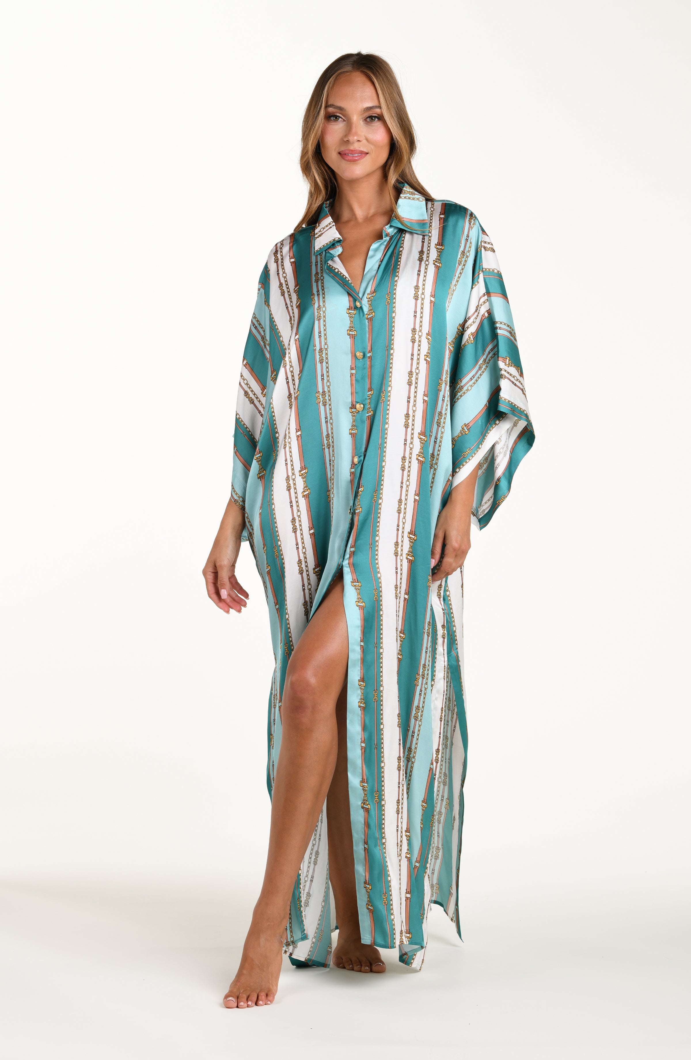 Front image of model wearing a belt-and-chain printed shirt dress cover up featuring a maxi length, gold button-down styling, with a collar and short sleeves.