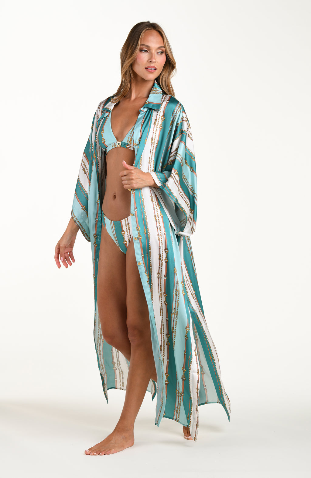 Front image of model wearing a belt-and-chain printed shirt dress cover up featuring a maxi length, gold button-down styling, with a collar and short sleeves.