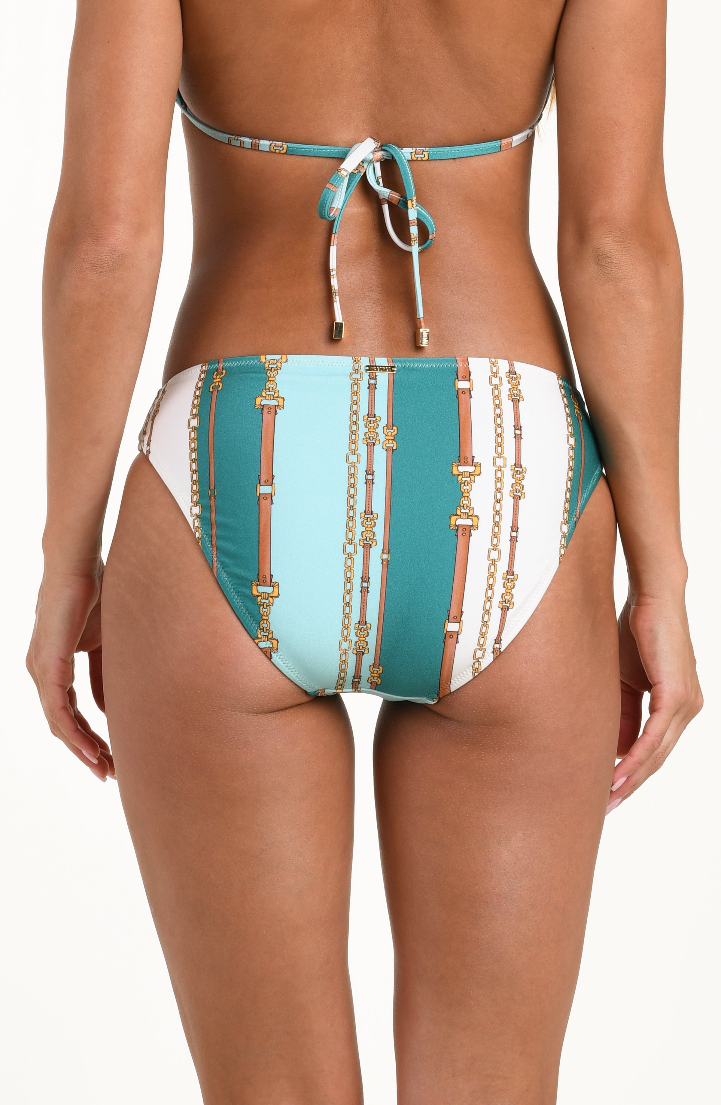 Back image of model wearing a belt-and-chain printed bikini bottom featuring a mid-rise fit, gold logo hardware, and moderate rear coverage.