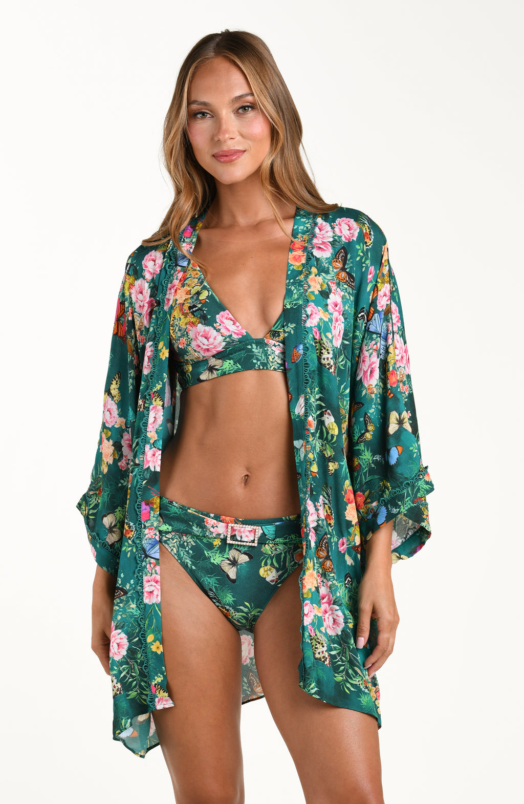 Front image of model wearing a multicolored floral printed kimono cover up featuring an open front, long wide sleeves, and a removable faux pearl belt. 