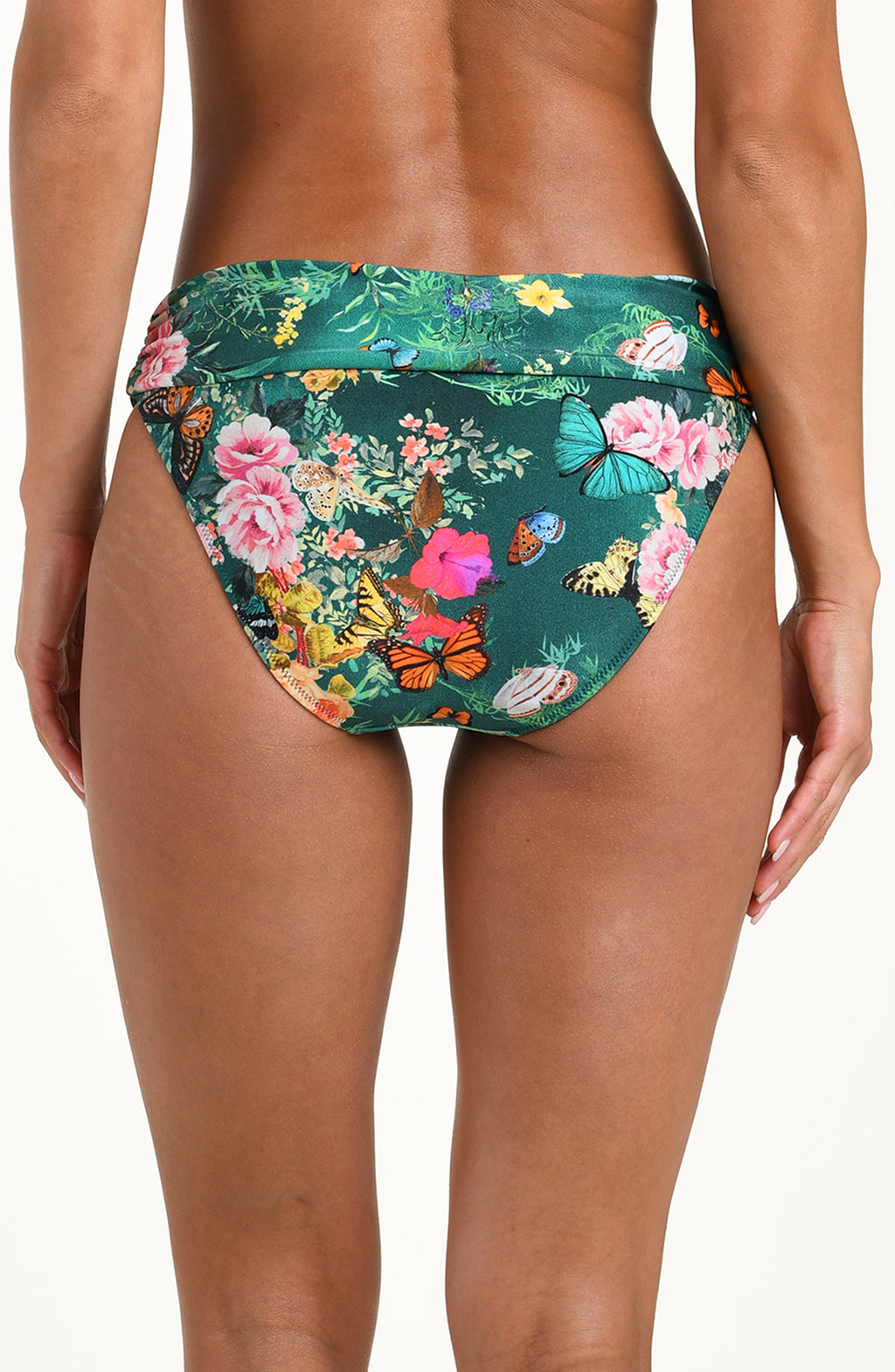 Back image of model wearing a multicolored floral printed bikini bottom featuring a soft waistband and moderate rear coverage.