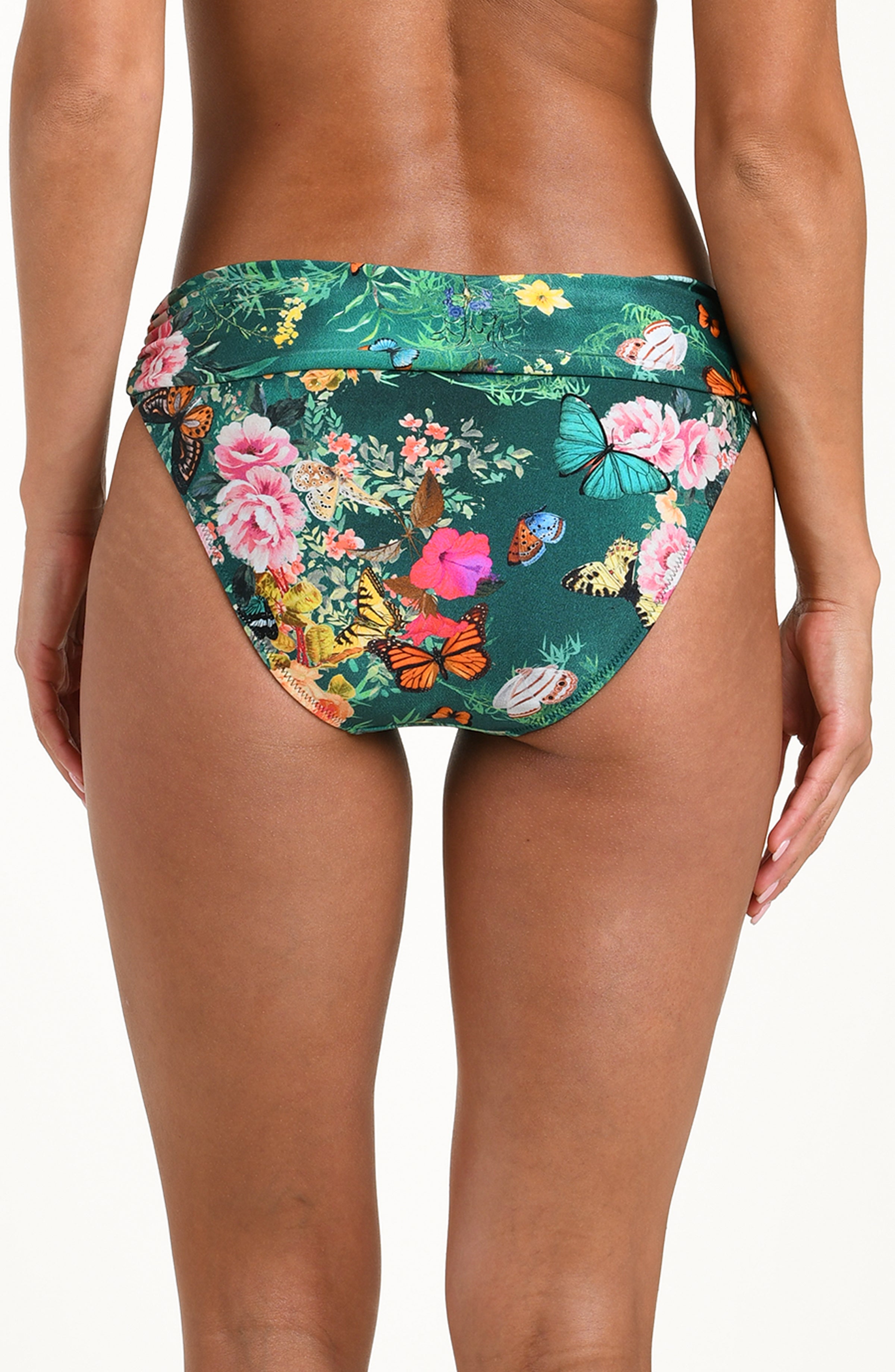 Back image of model wearing a multicolored floral printed bikini bottom featuring a soft waistband and moderate rear coverage.