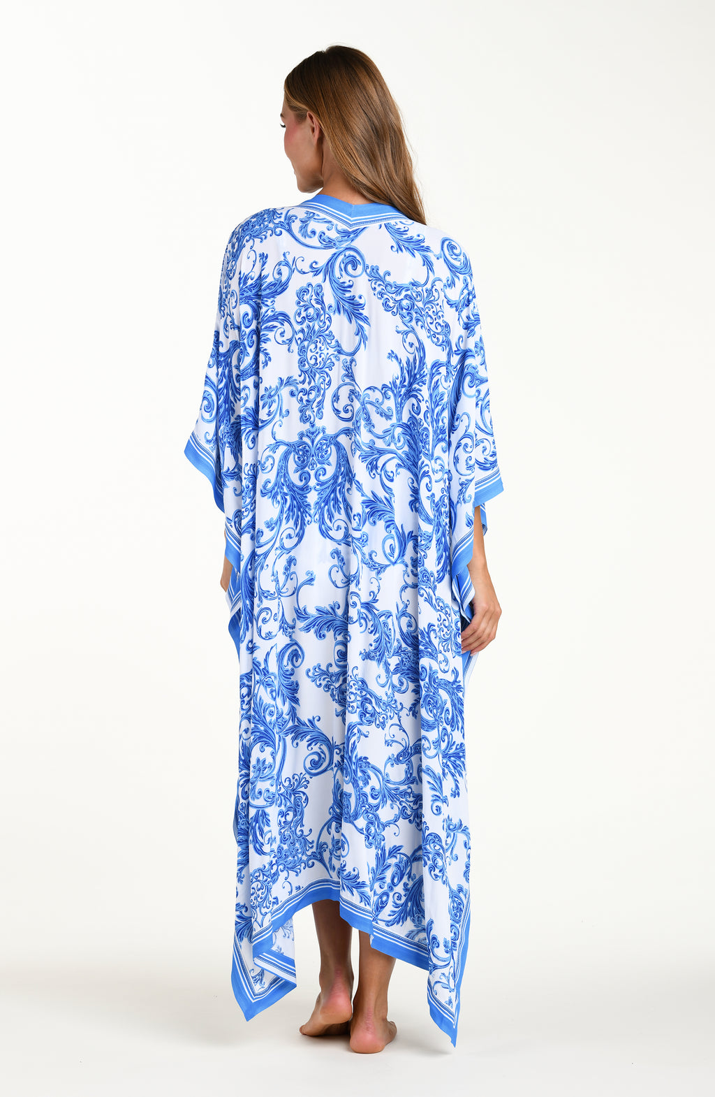 Woman wearing a blue and white patterned kimono-style garment on a white background