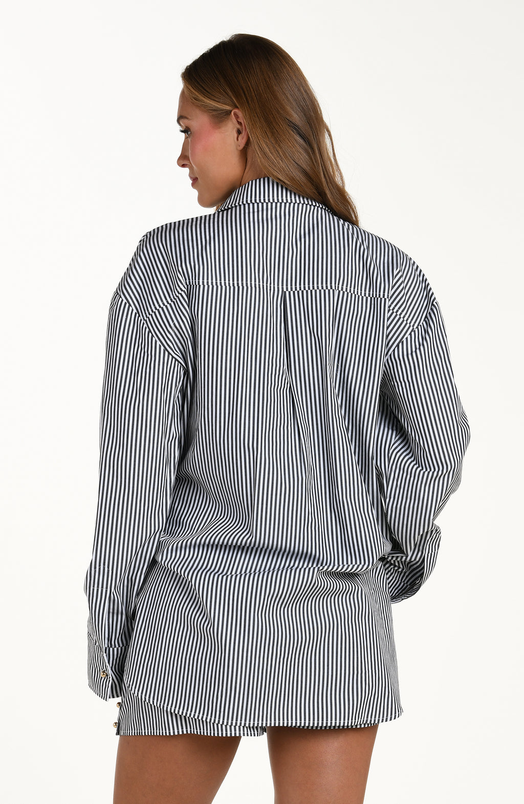 Woman wearing a black and white striped shirt on a white background
