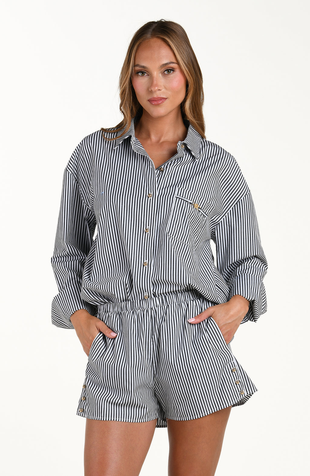 Woman wearing a striped shirt and shorts set on a white background