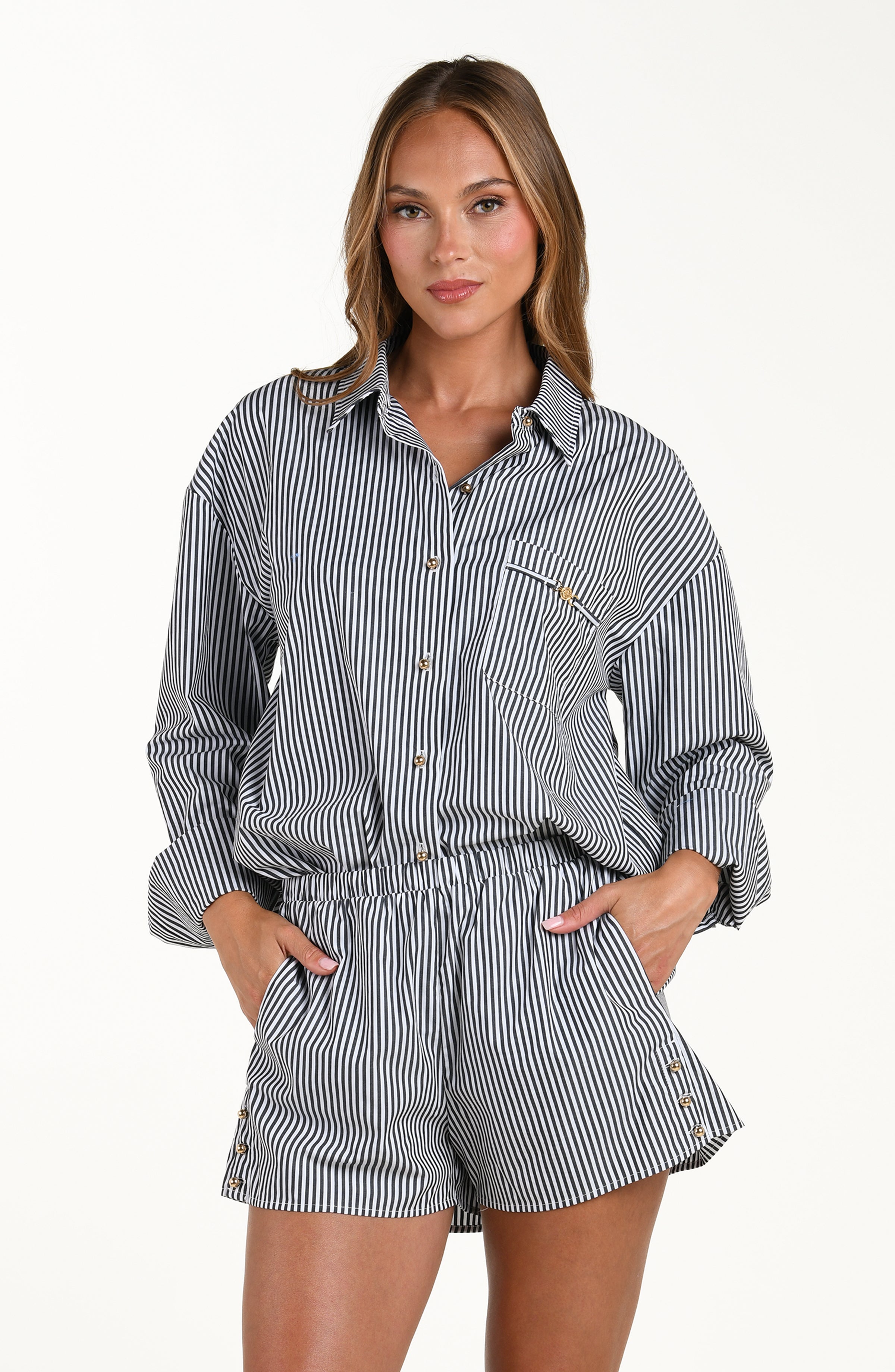 Woman wearing a striped shirt and shorts set on a white background