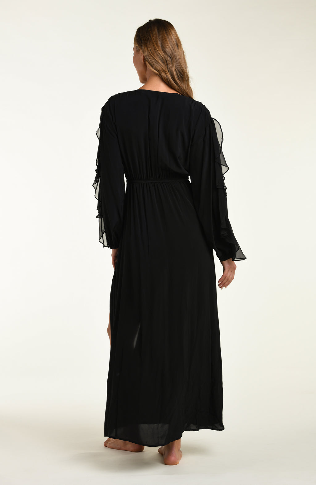 Woman wearing a black long-sleeve dress on a white background