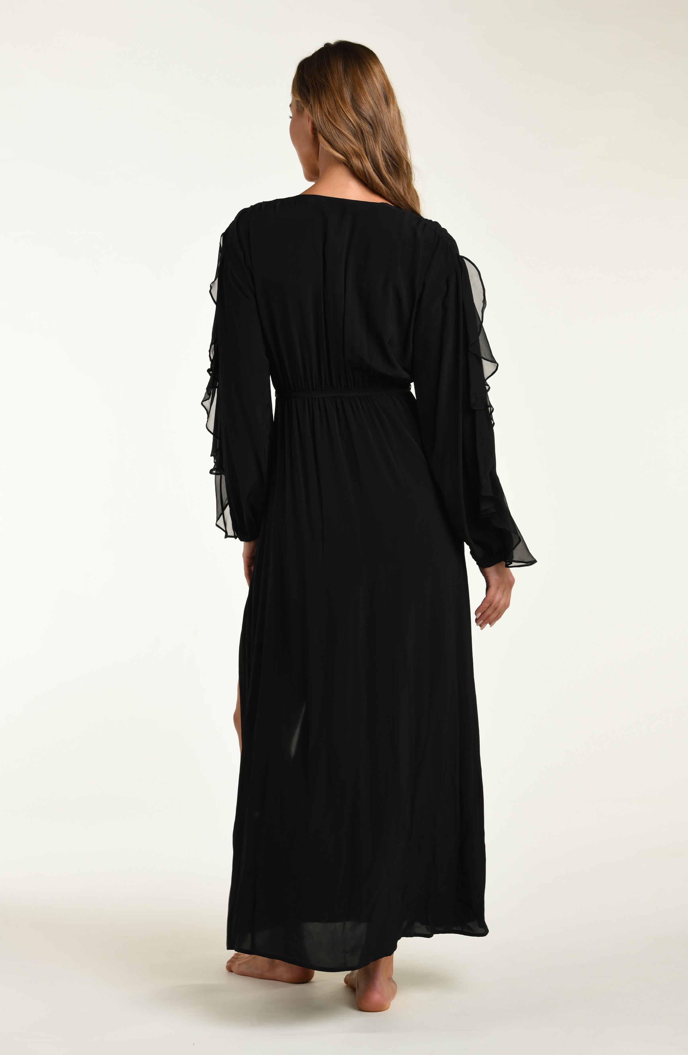 Woman wearing a black long-sleeve dress on a white background