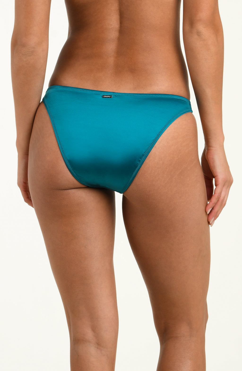 Teal bikini bottom worn by a person on a white background