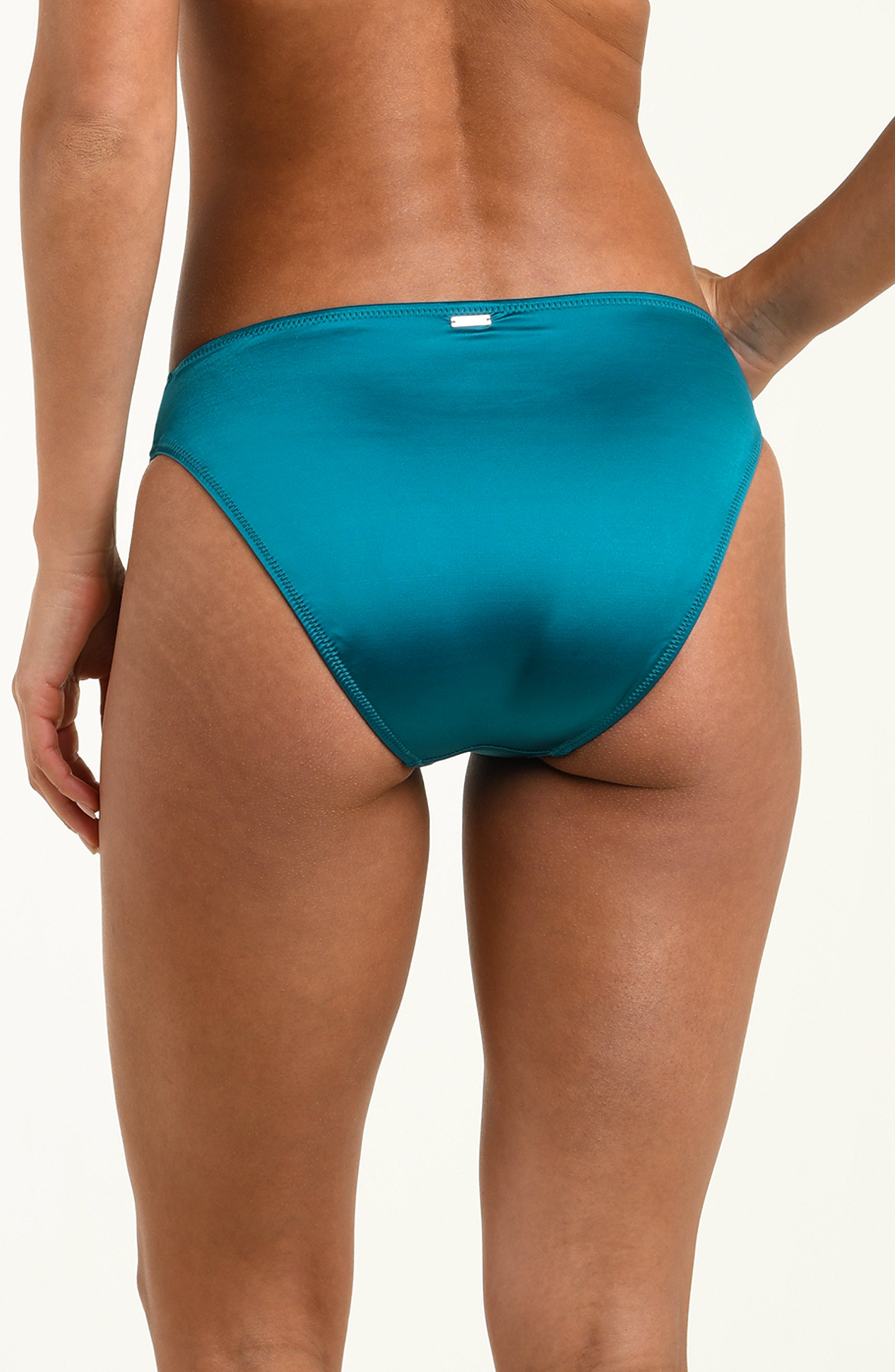 Teal bikini bottom worn by a person on a white background