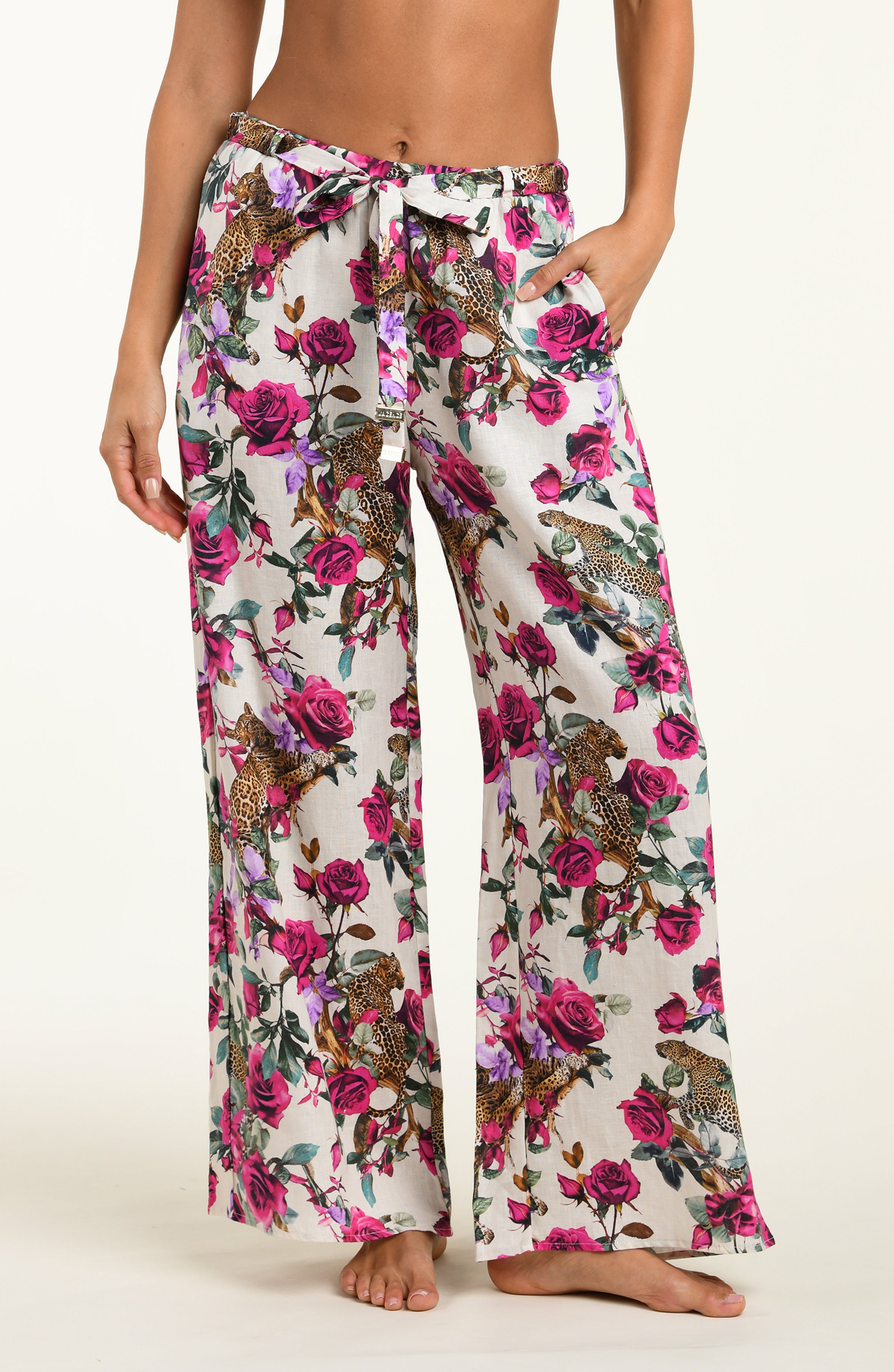 Floral patterned pants worn by a person on a white background