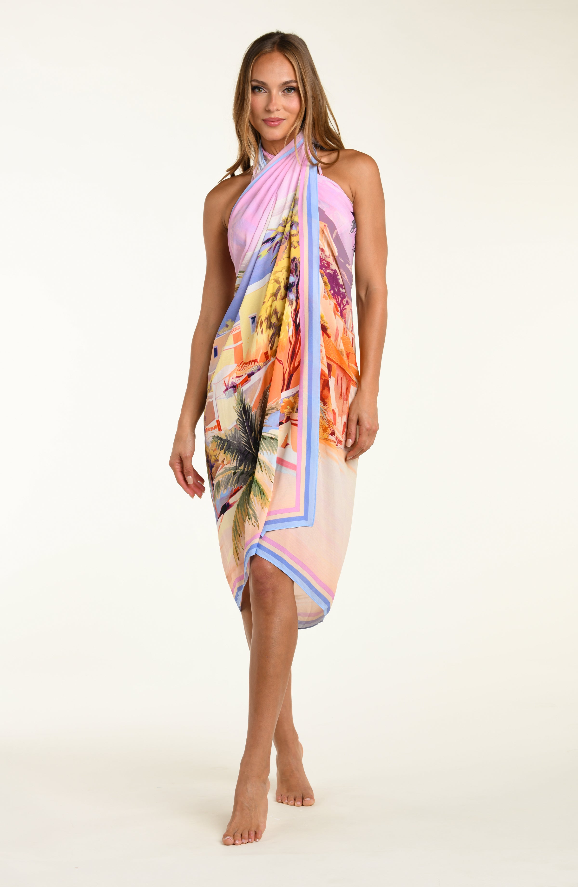 Woman wearing a colorful floral dress on a white background