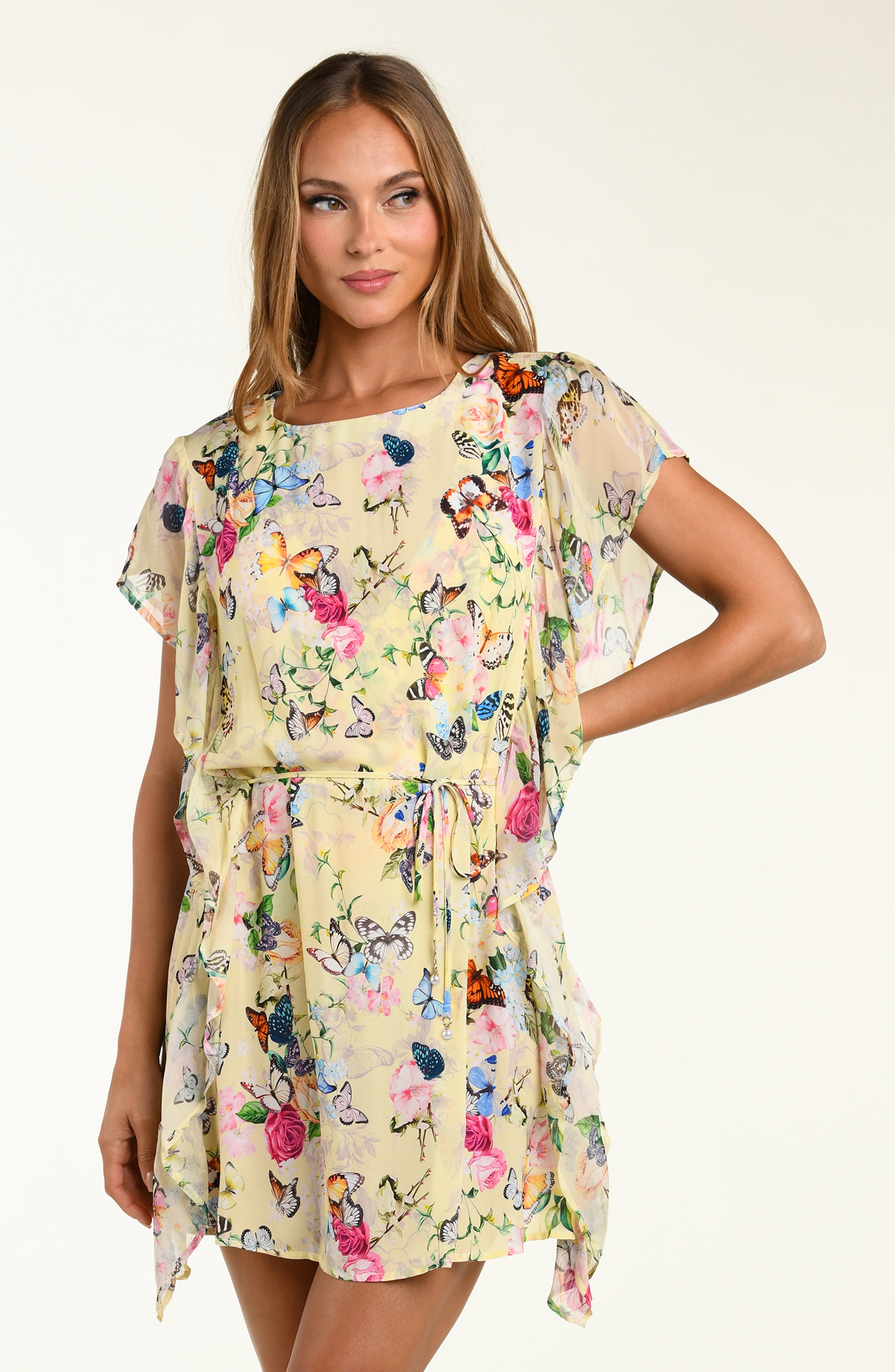 Woman wearing a floral dress with a plain background