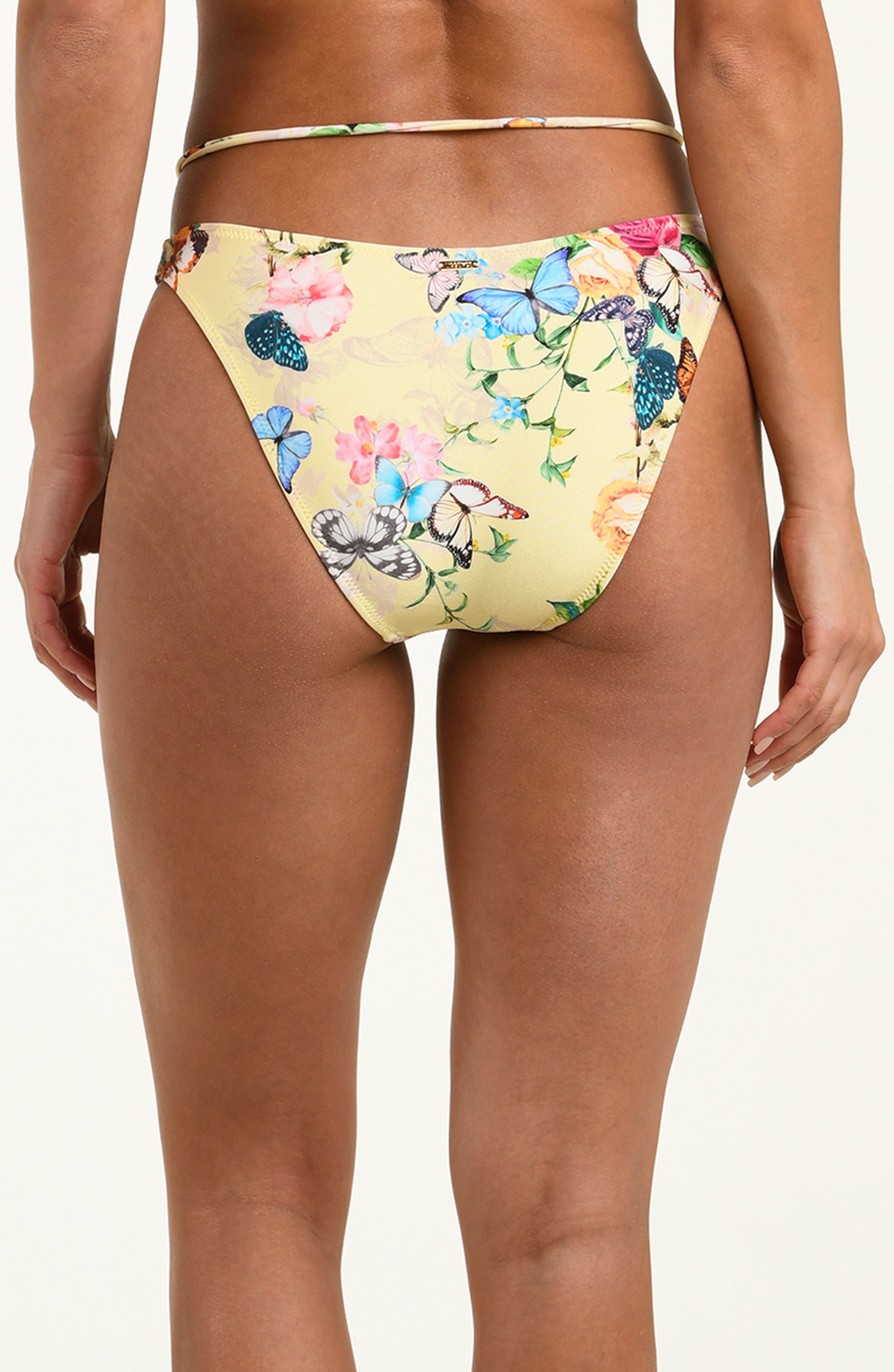 Colorful floral and butterfly-patterned bikini bottom on a plain background
