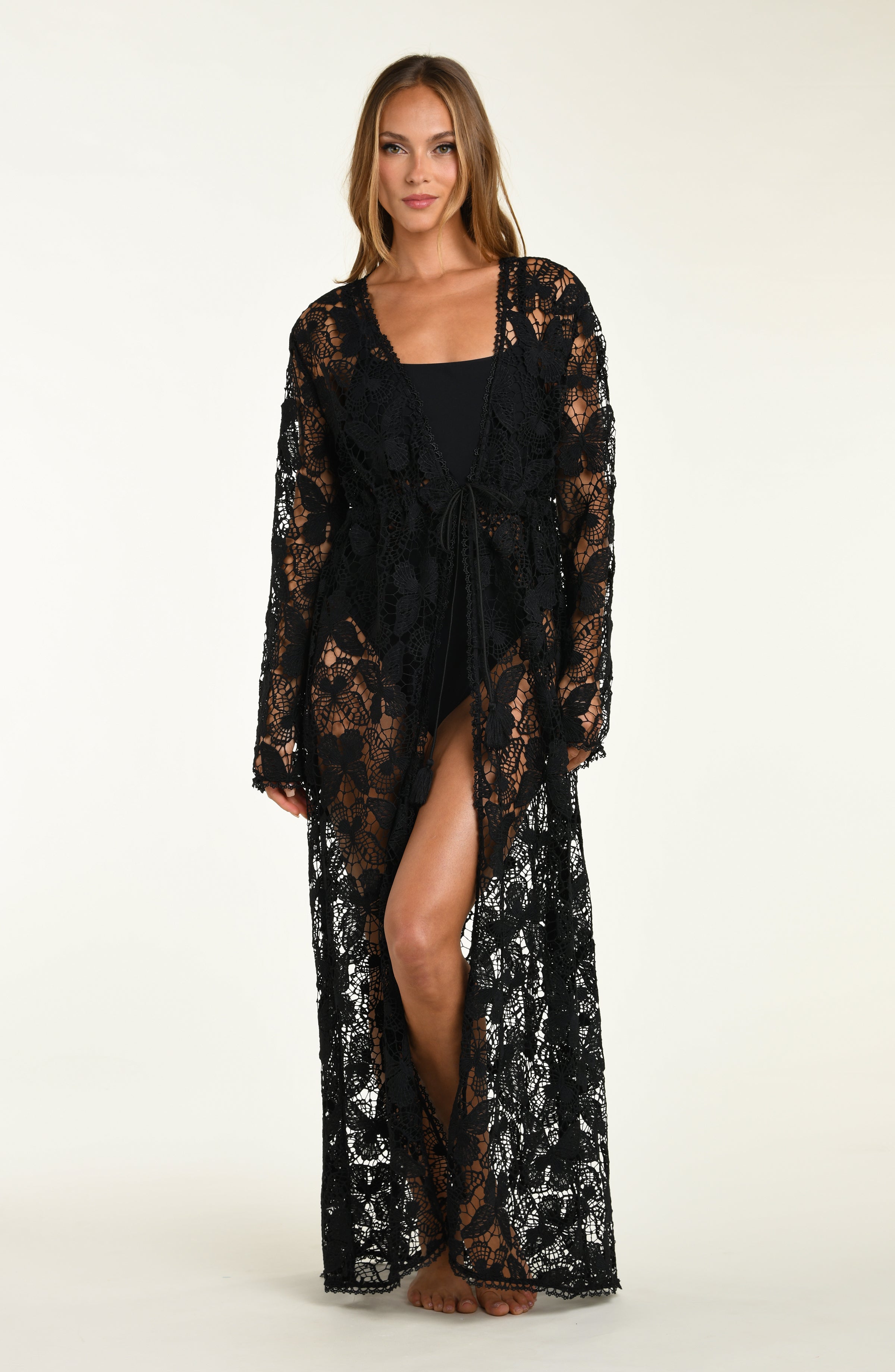 Woman wearing a black lace robe on a white background