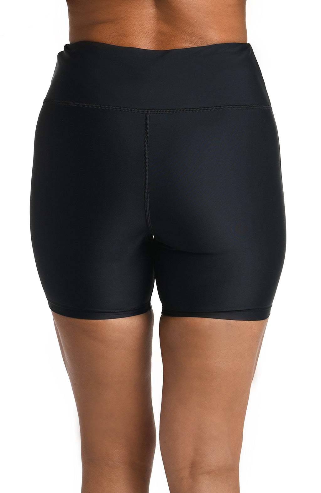 Black bike shorts worn by a person on a white background