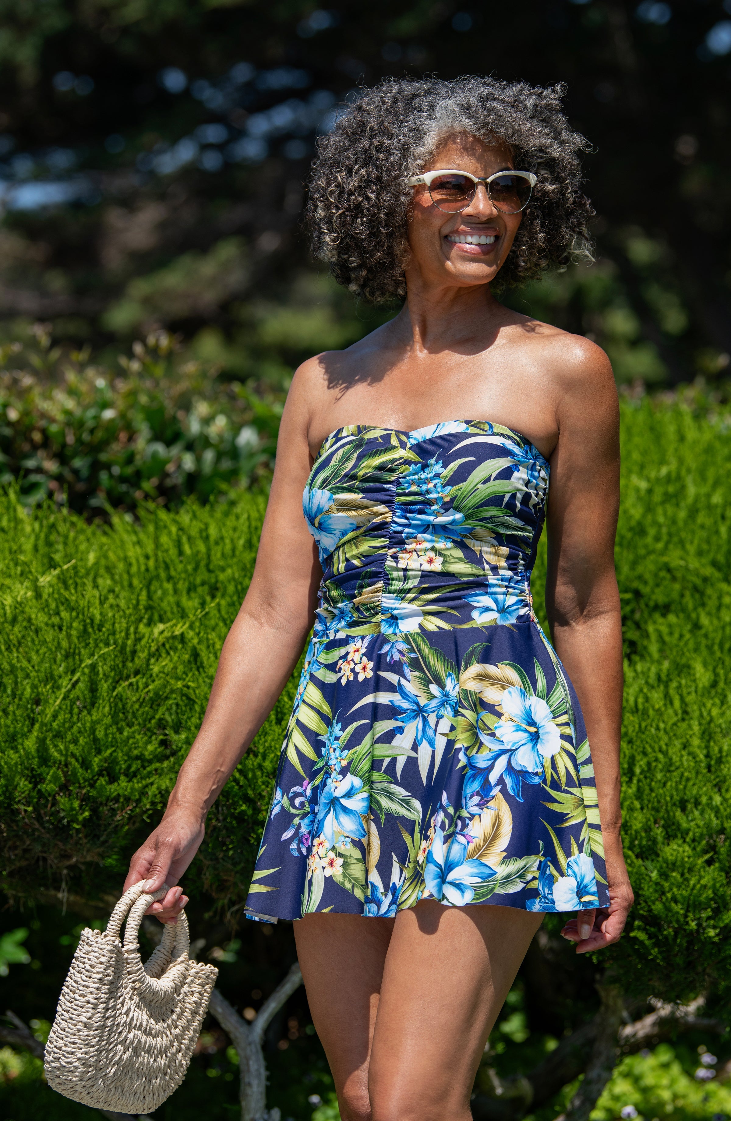 Woman wearing a strapless floral dress in an outdoor setting