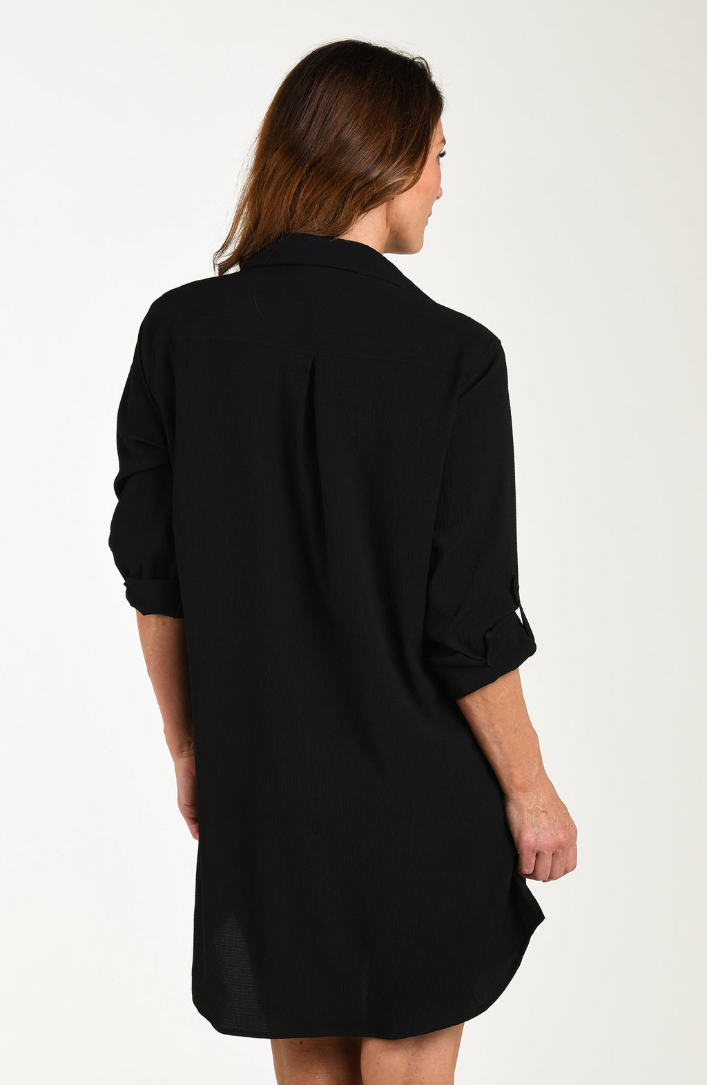 Woman wearing a black dress against a white background