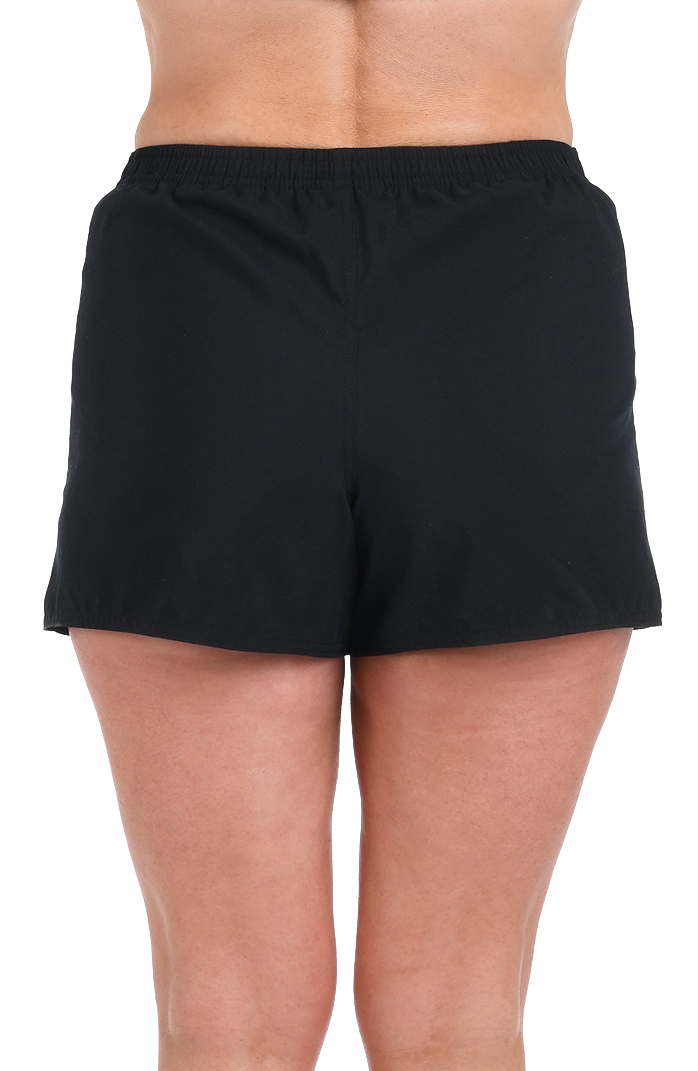 Black board shorts worn by a person on a white background