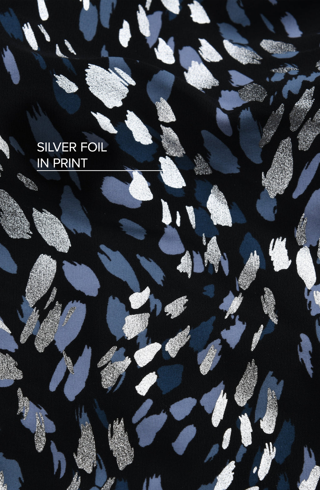 Patterned fabric with silver foil inks on a black background