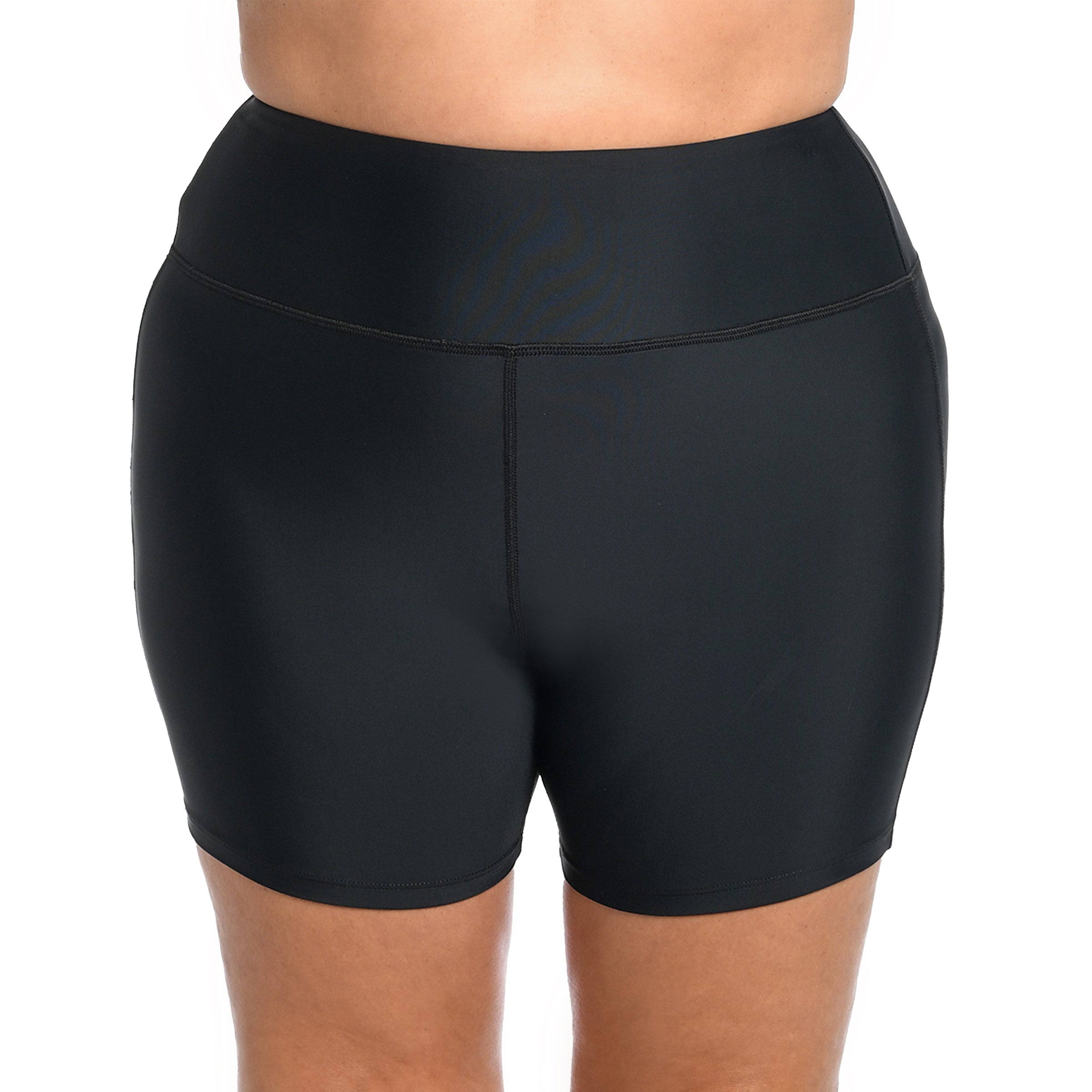 Black bike shorts worn by a person on a white background