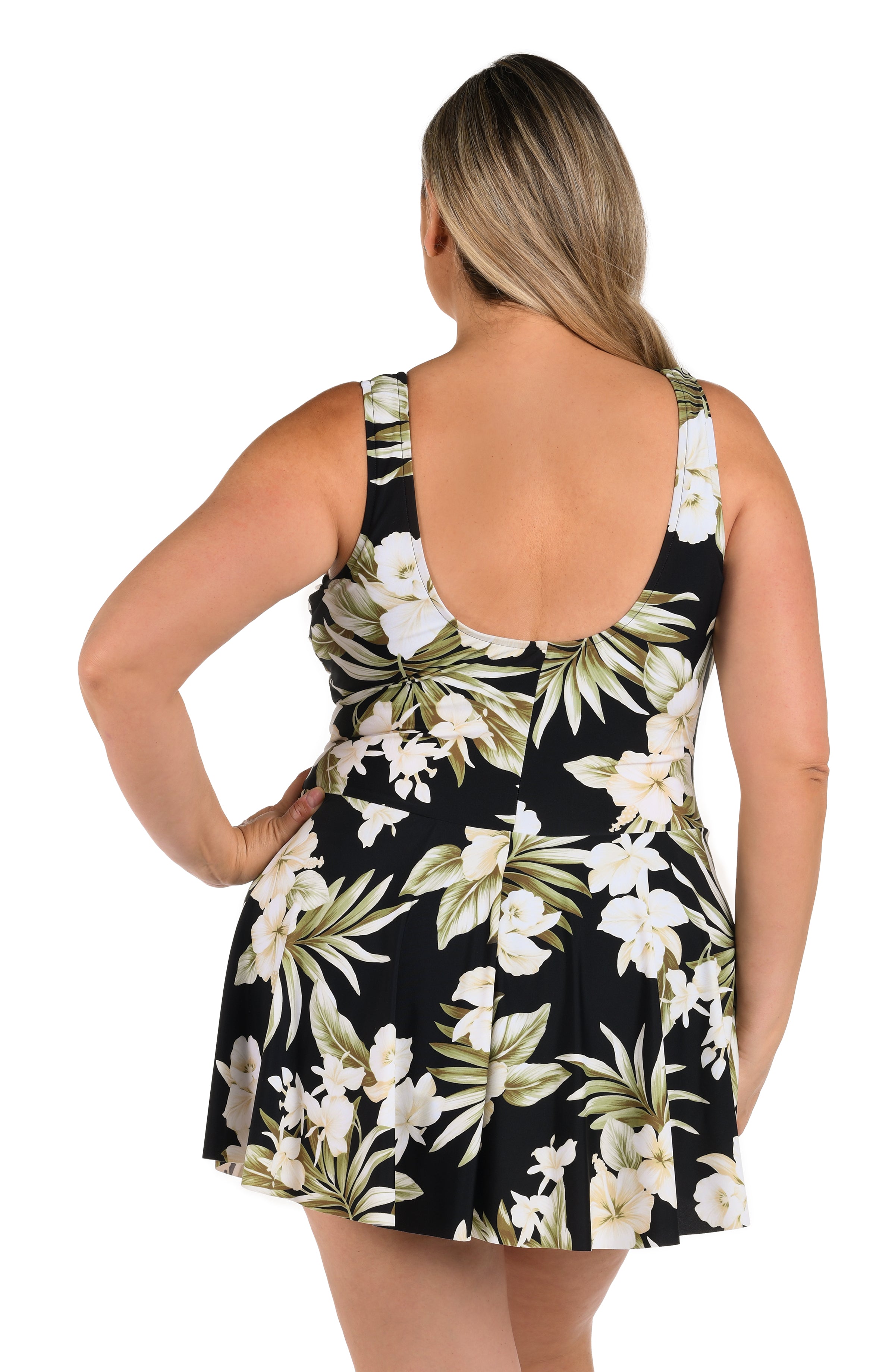 Woman wearing a black floral swim dress with a white background