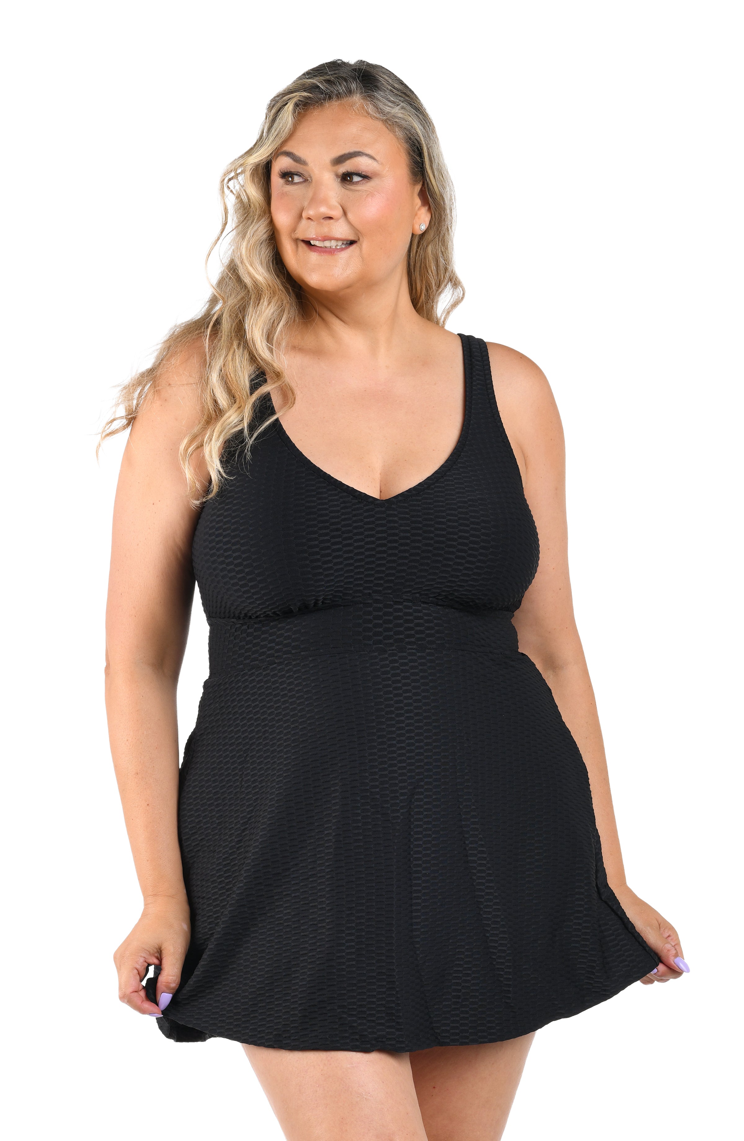 Woman wearing a black one piece swim dress on a white background