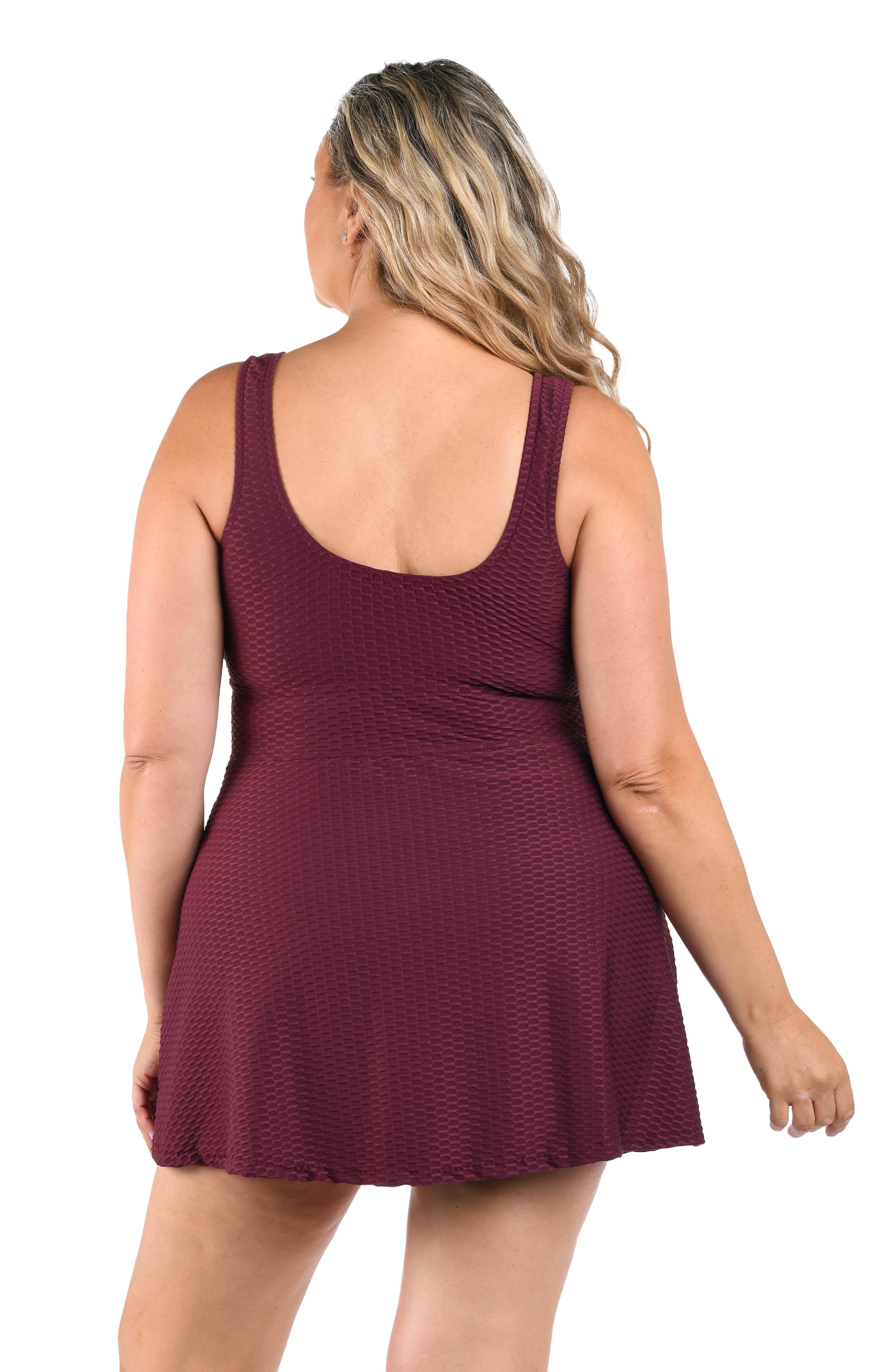 Woman wearing a burgundy dress on a white background