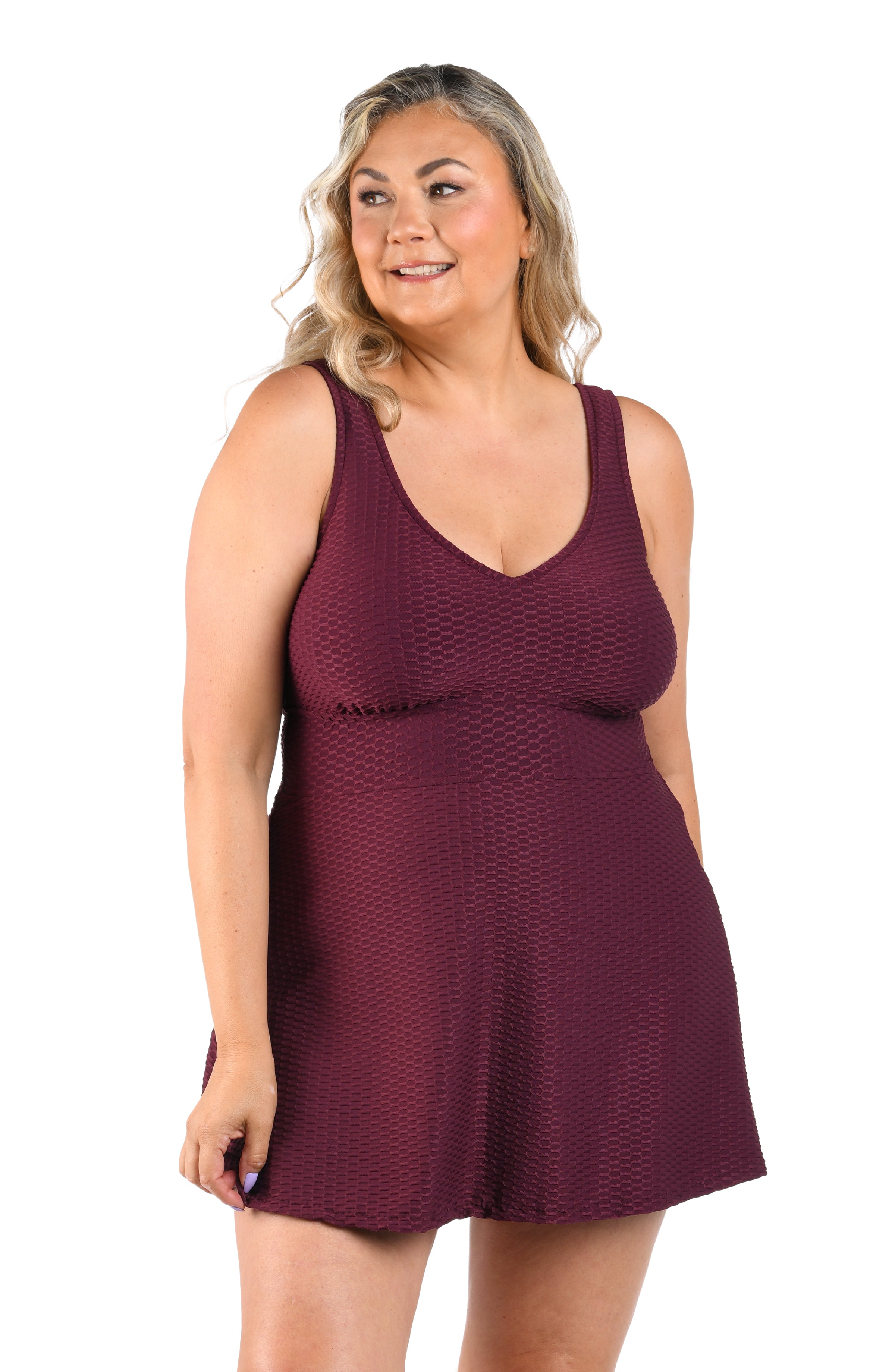 Woman wearing a burgundy sleeveless dress on a white background