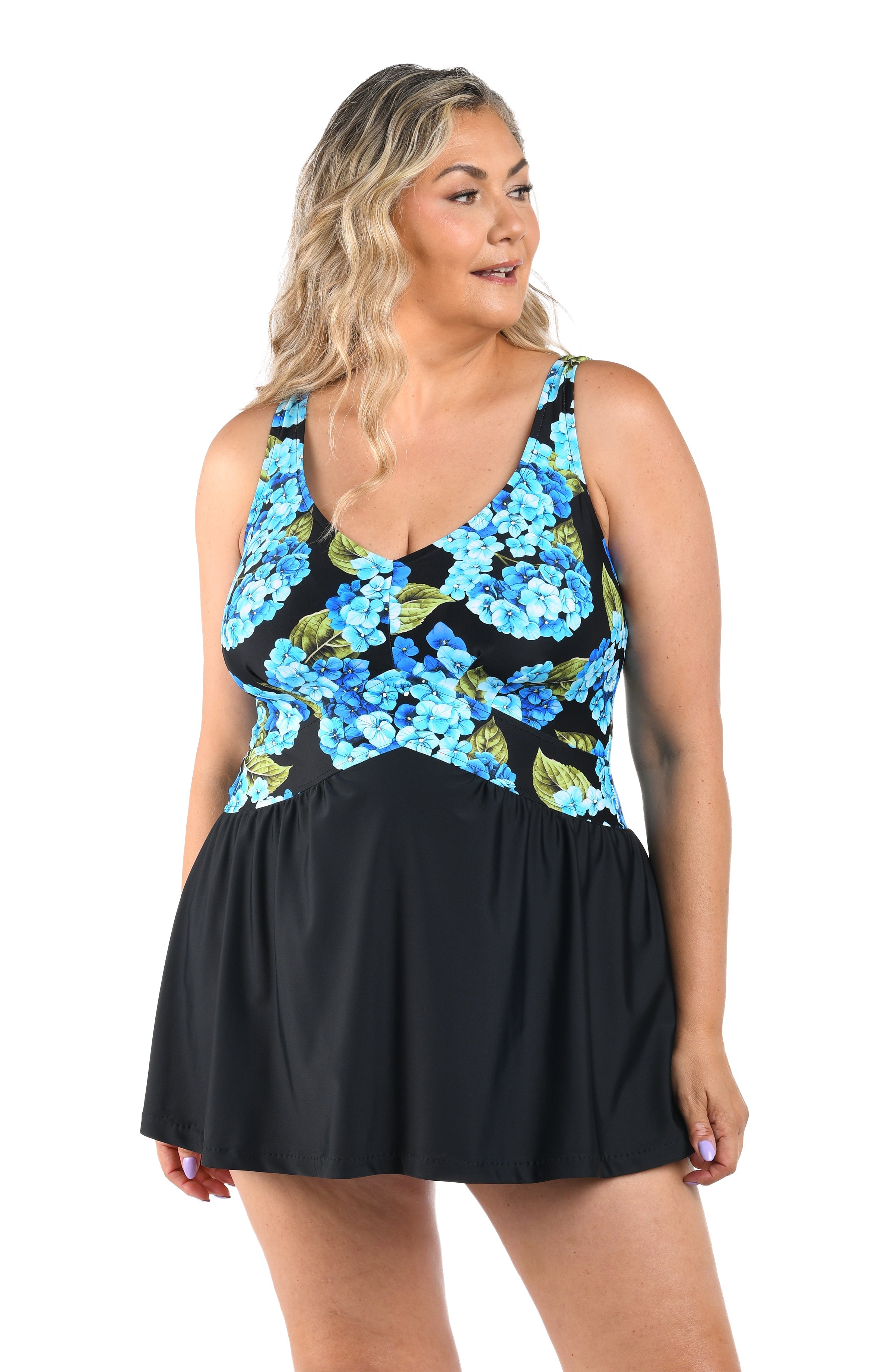 Woman wearing a black dress with blue floral pattern on a white background