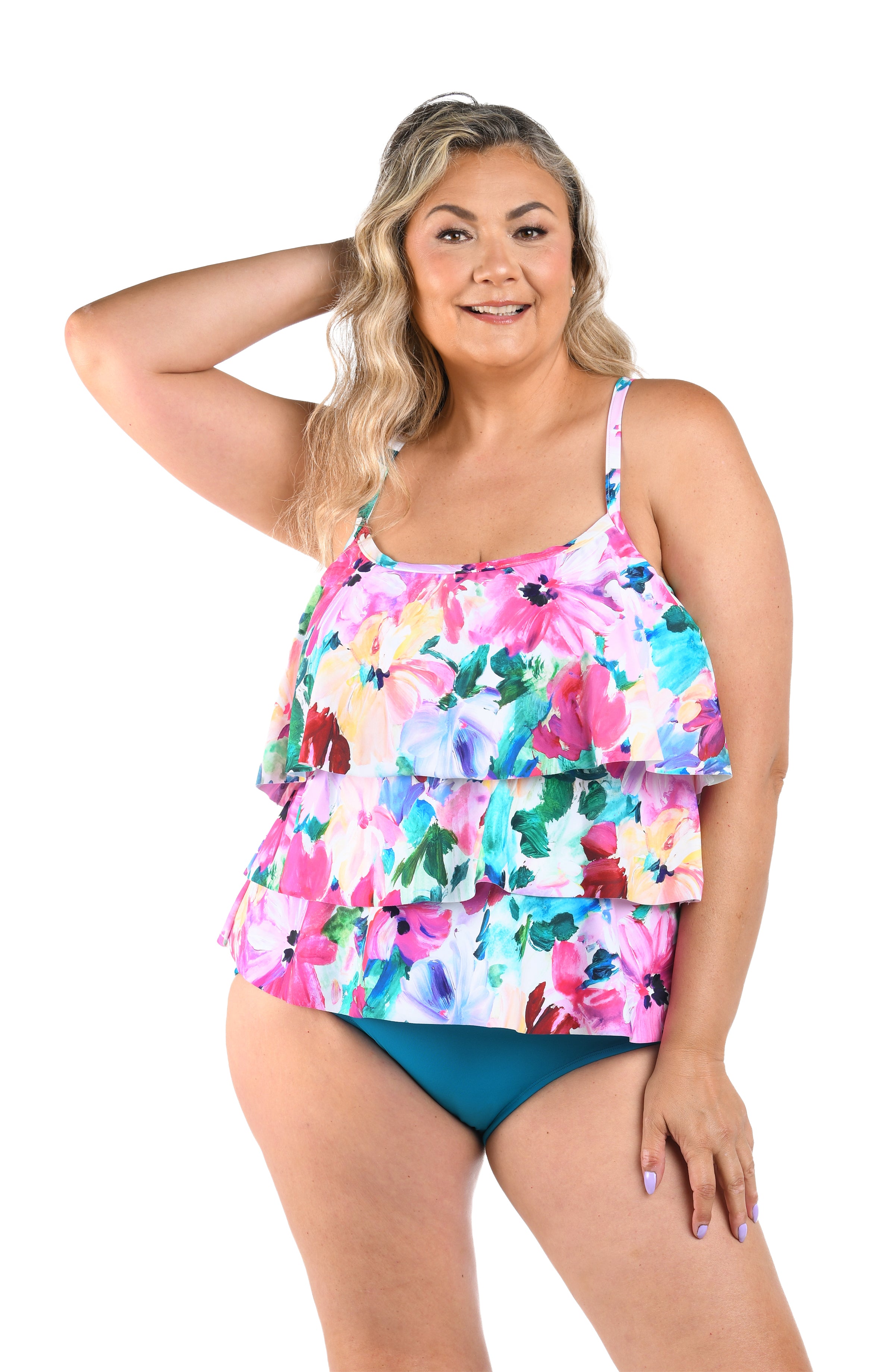 Woman wearing a multicolored floral printed tankini top against a white background. 