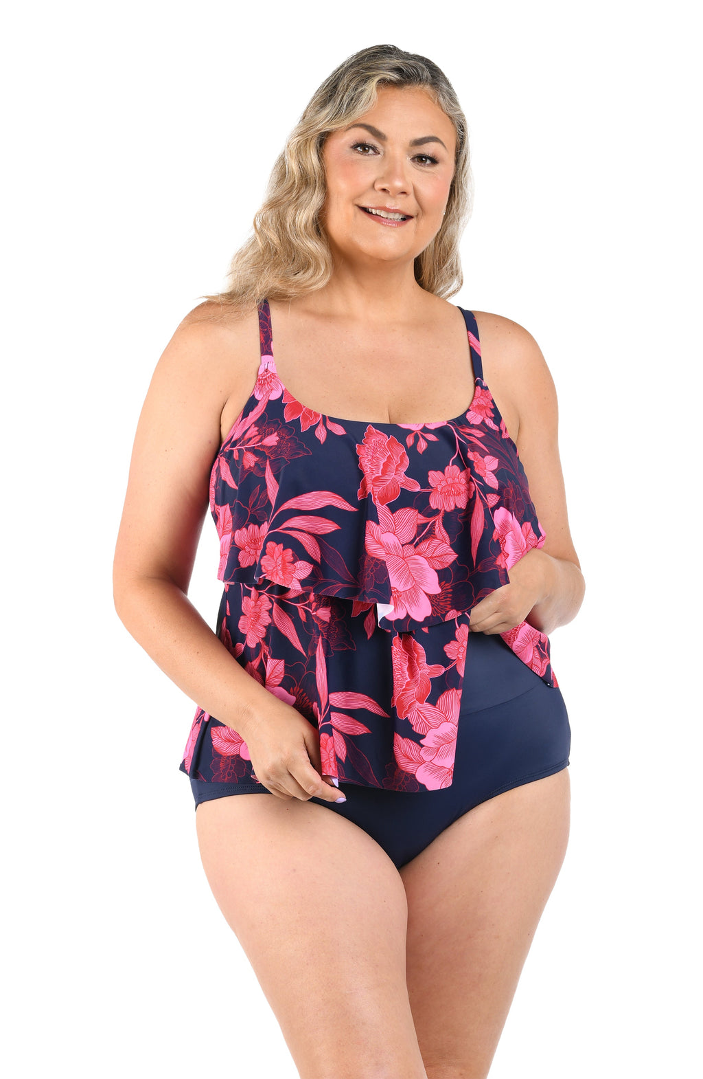 Woman wearing a navy blue and pink floral swimsuit on a white background