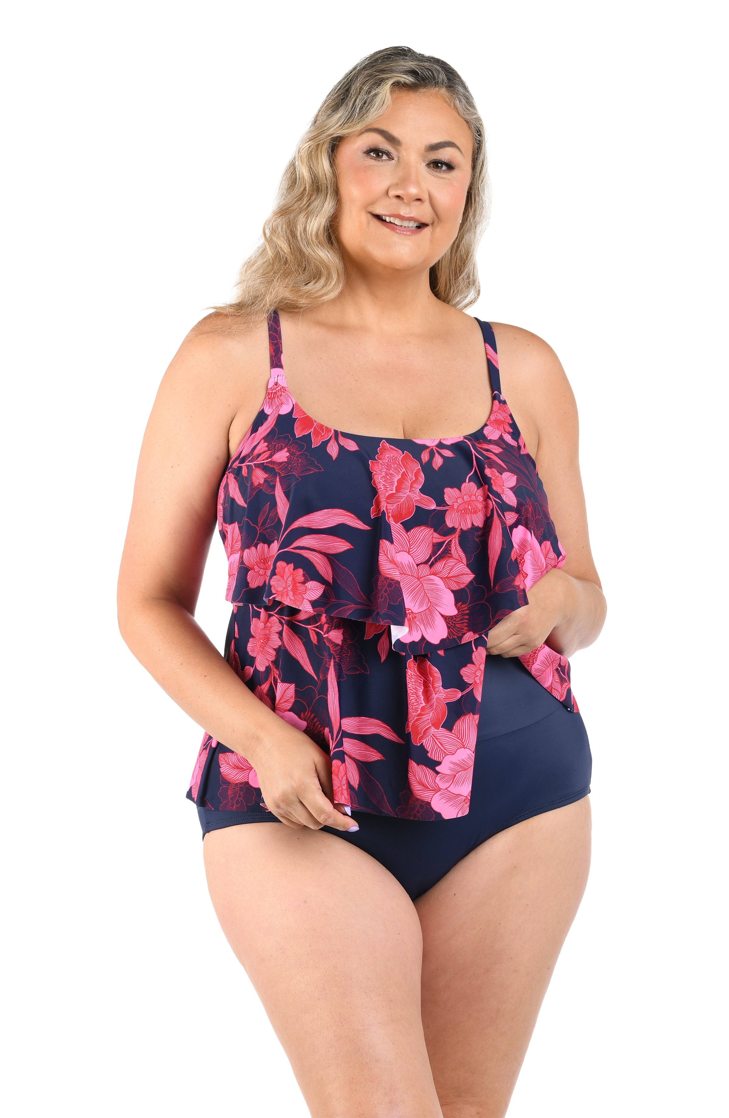 Woman wearing a navy blue and pink floral swimsuit on a white background