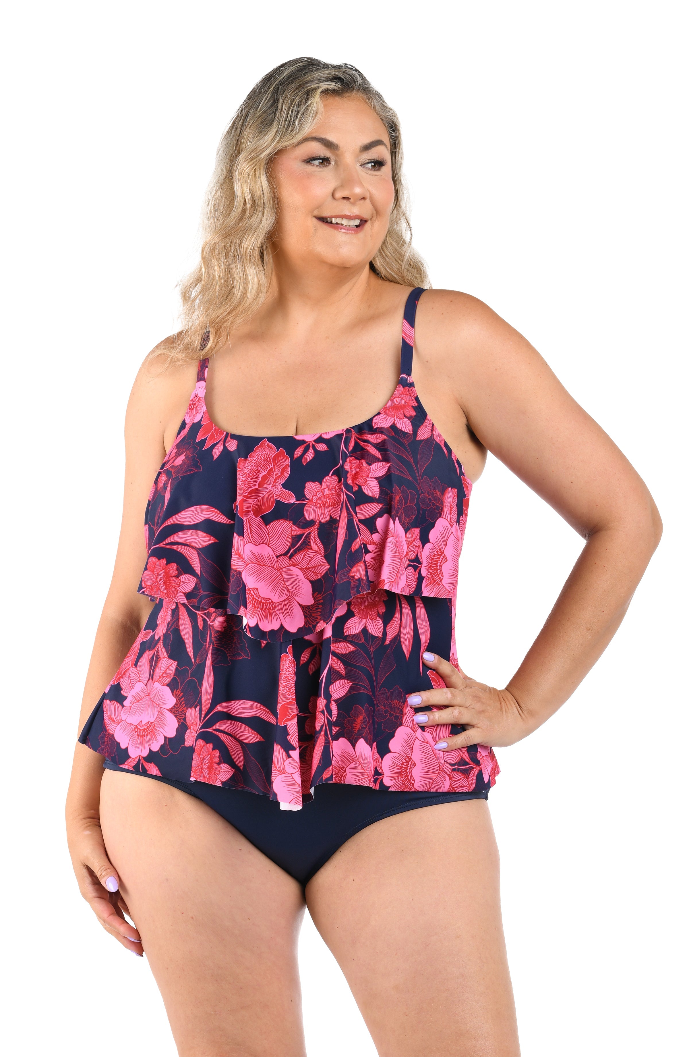 Woman wearing a floral swimsuit with pink and purple flowers on a white background