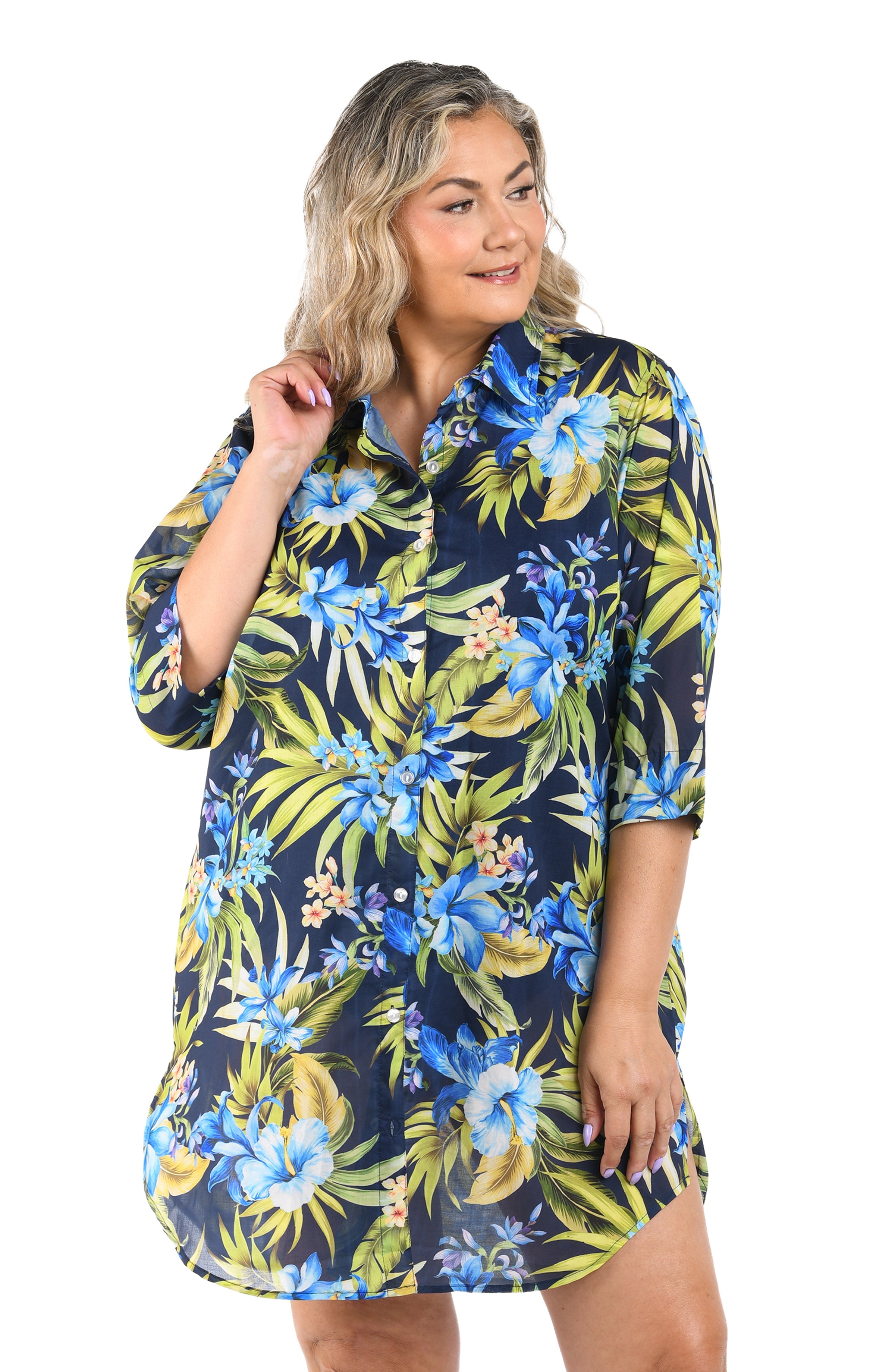 Woman wearing a navy floral dress with blue flowers and green leaves on a white background
