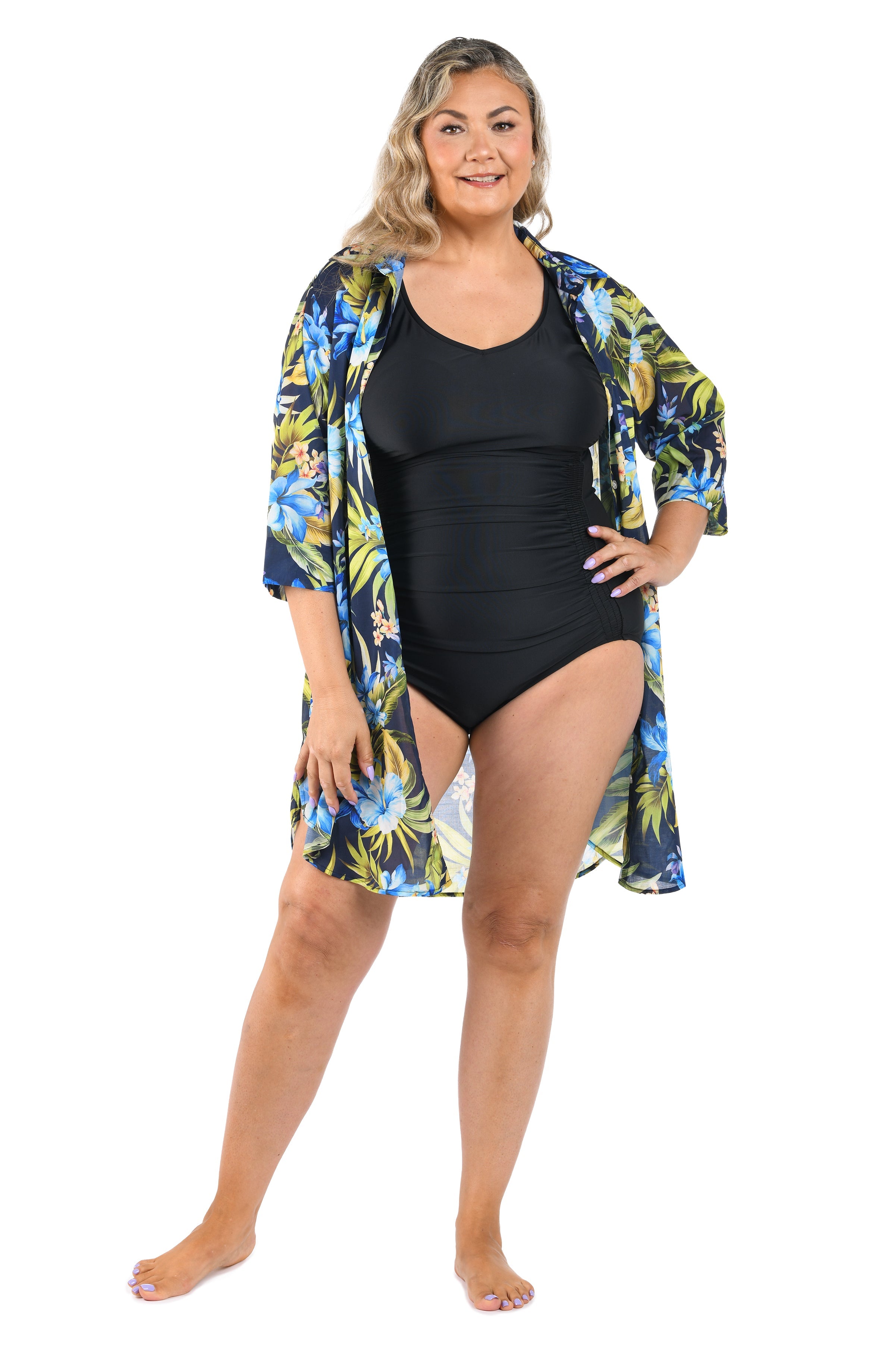 Woman wearing a black swimsuit with a floral cover-up on a white background