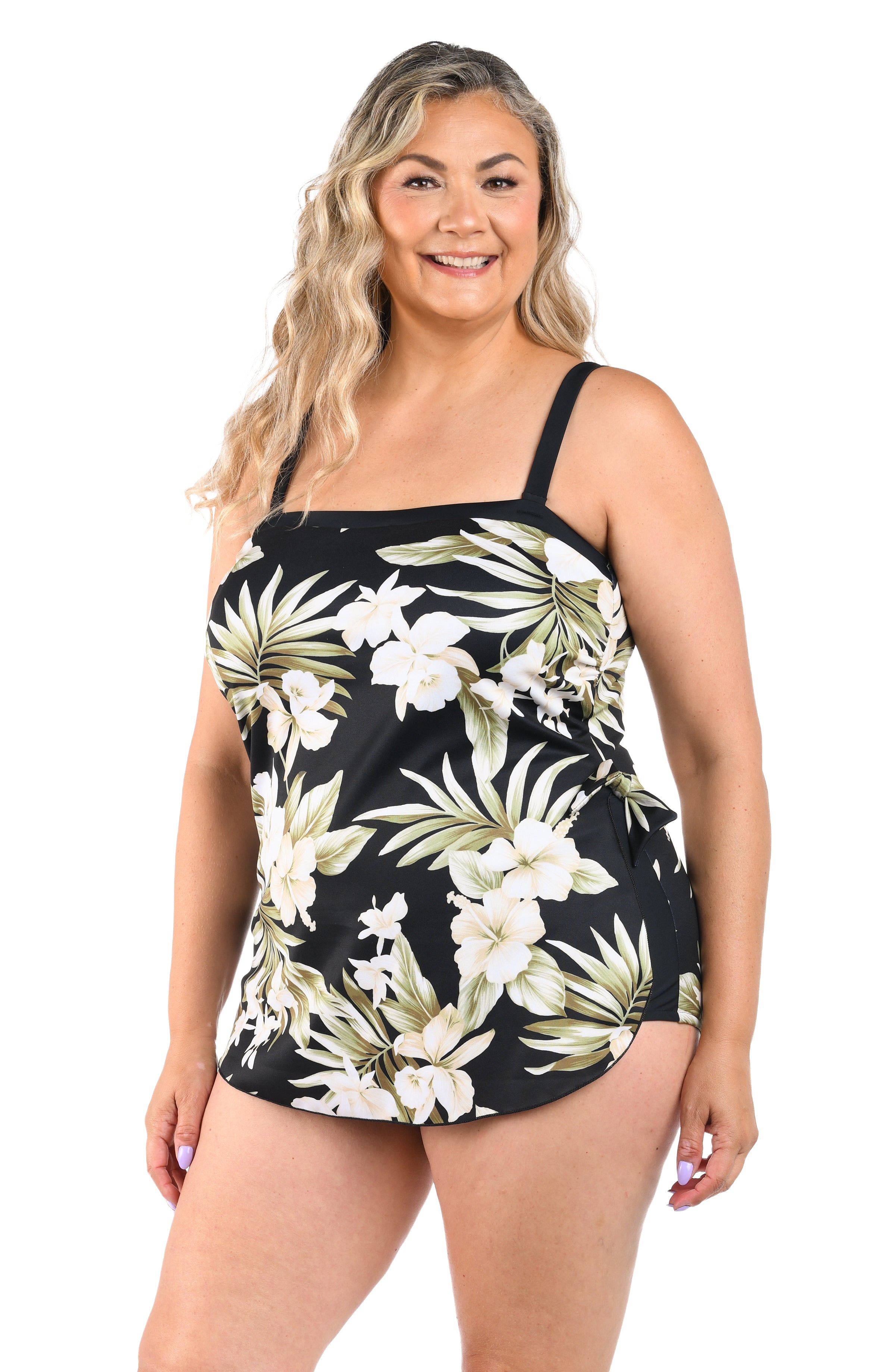 Woman wearing a black floral tankini top on a white background