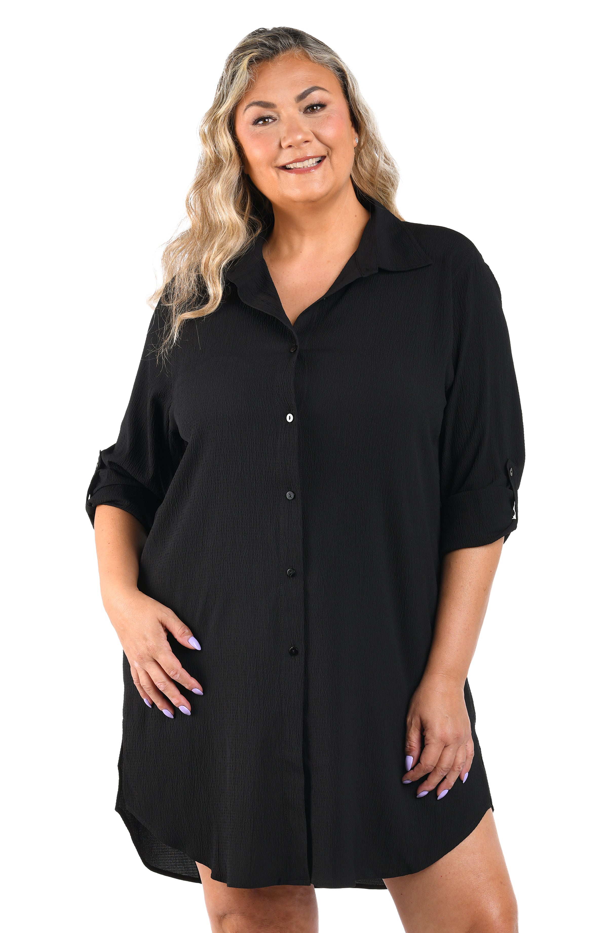 Woman wearing a black shirt dress on a white background