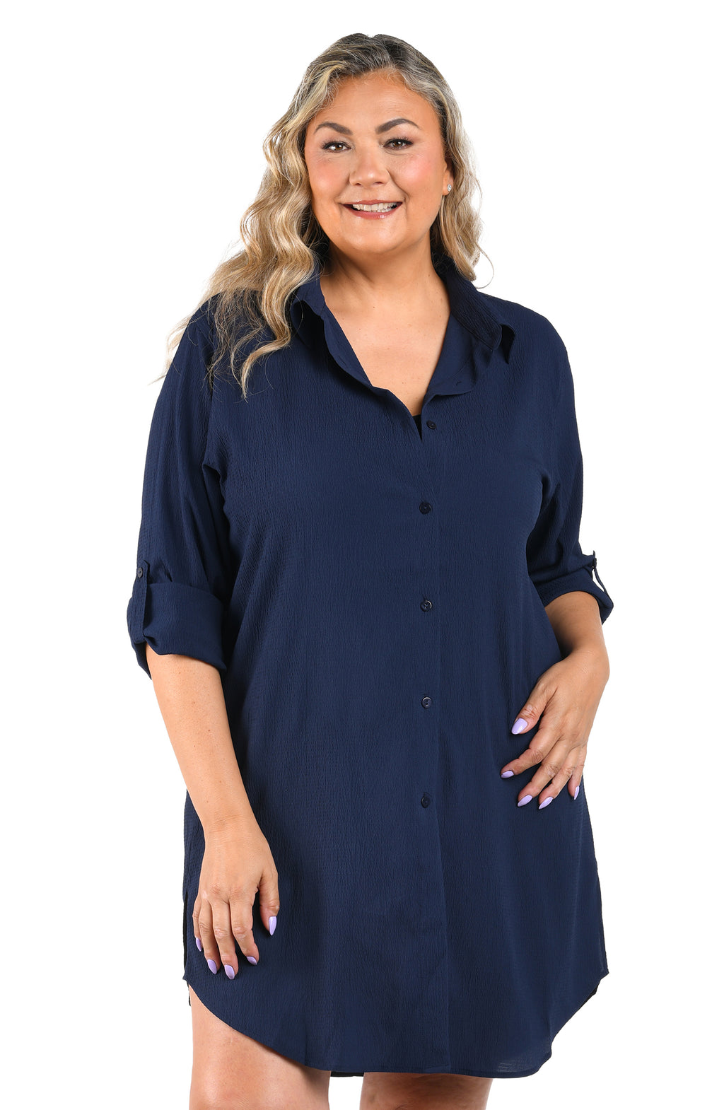 Woman wearing a navy blue dress with rolled-up sleeves on a white background