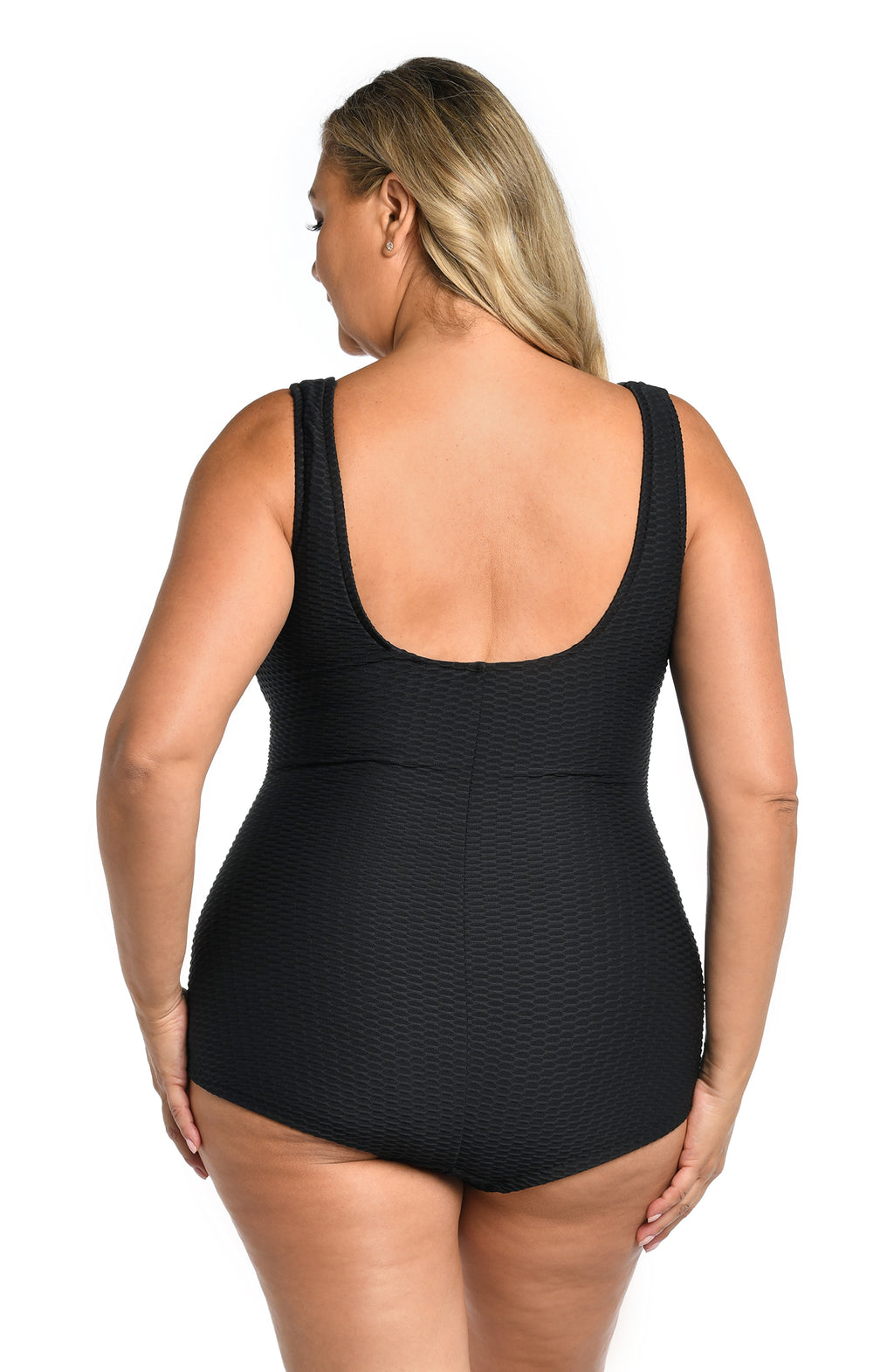 Person wearing a black one-piece swimsuit on a white background